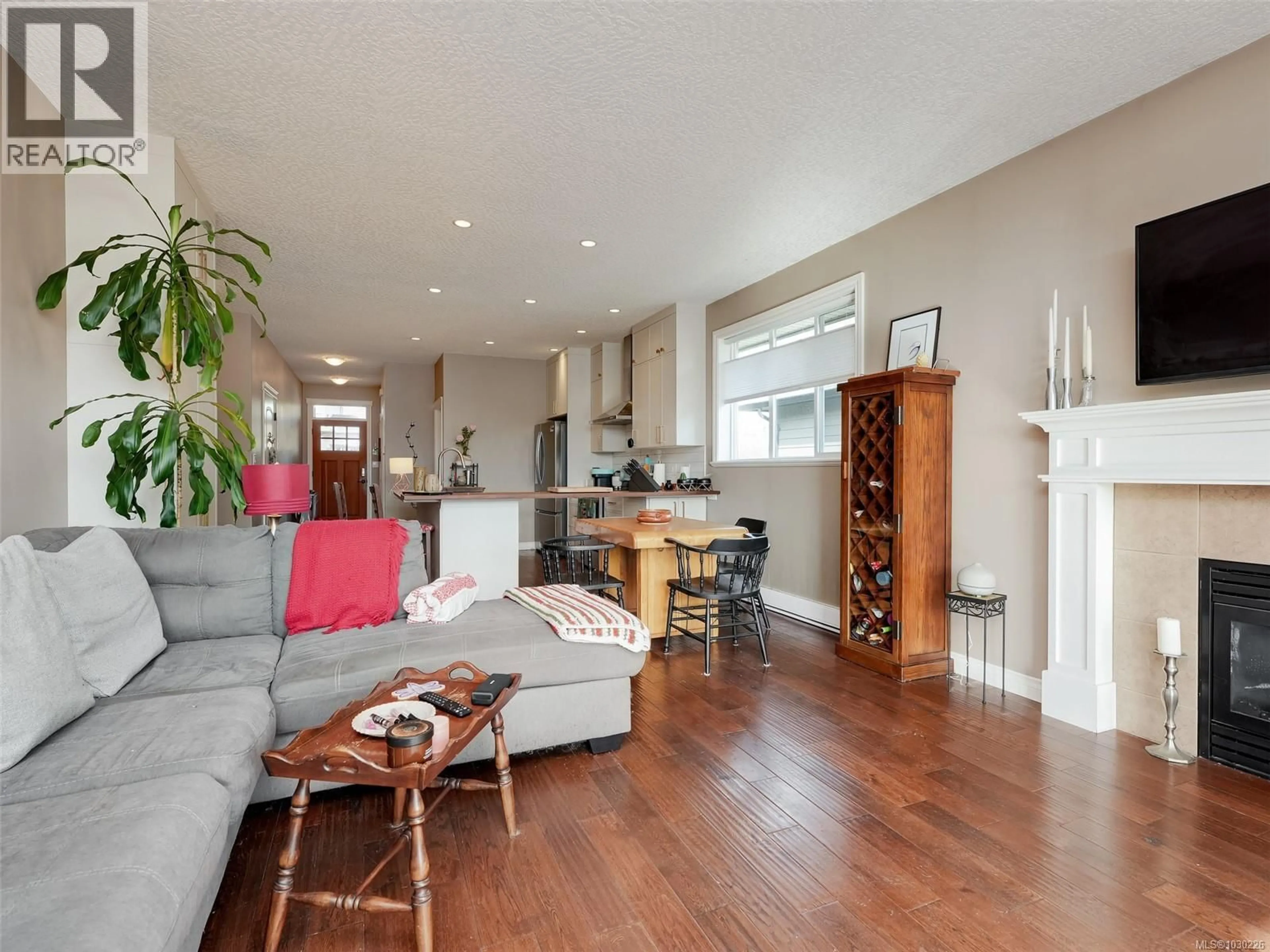Living room with furniture, wood/laminate floor for 6559 ARRANWOOD DRIVE, Sooke British Columbia V9Z0W4