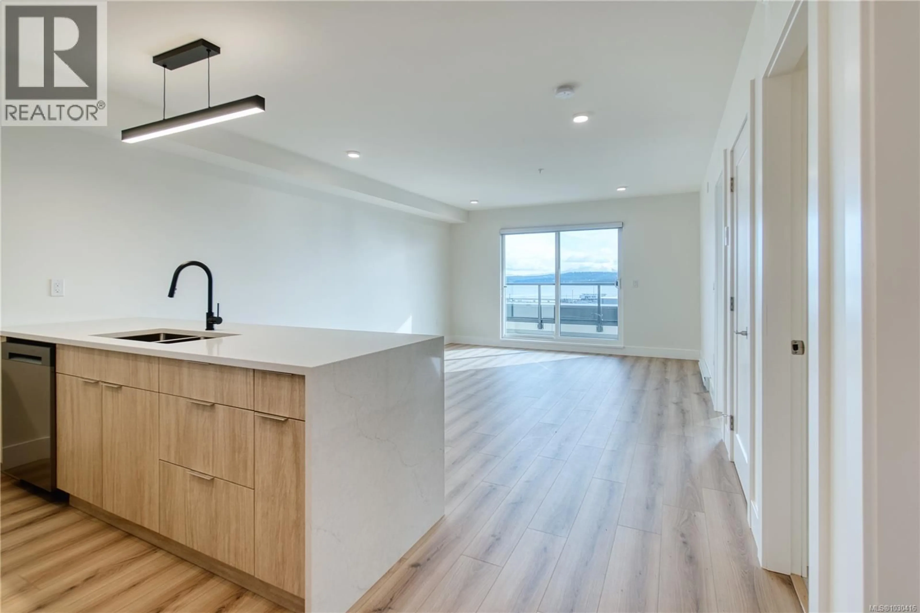 Open concept kitchen, wood/laminate floor for 404 - 45 HALIBURTON STREET, Nanaimo British Columbia V9R4V6
