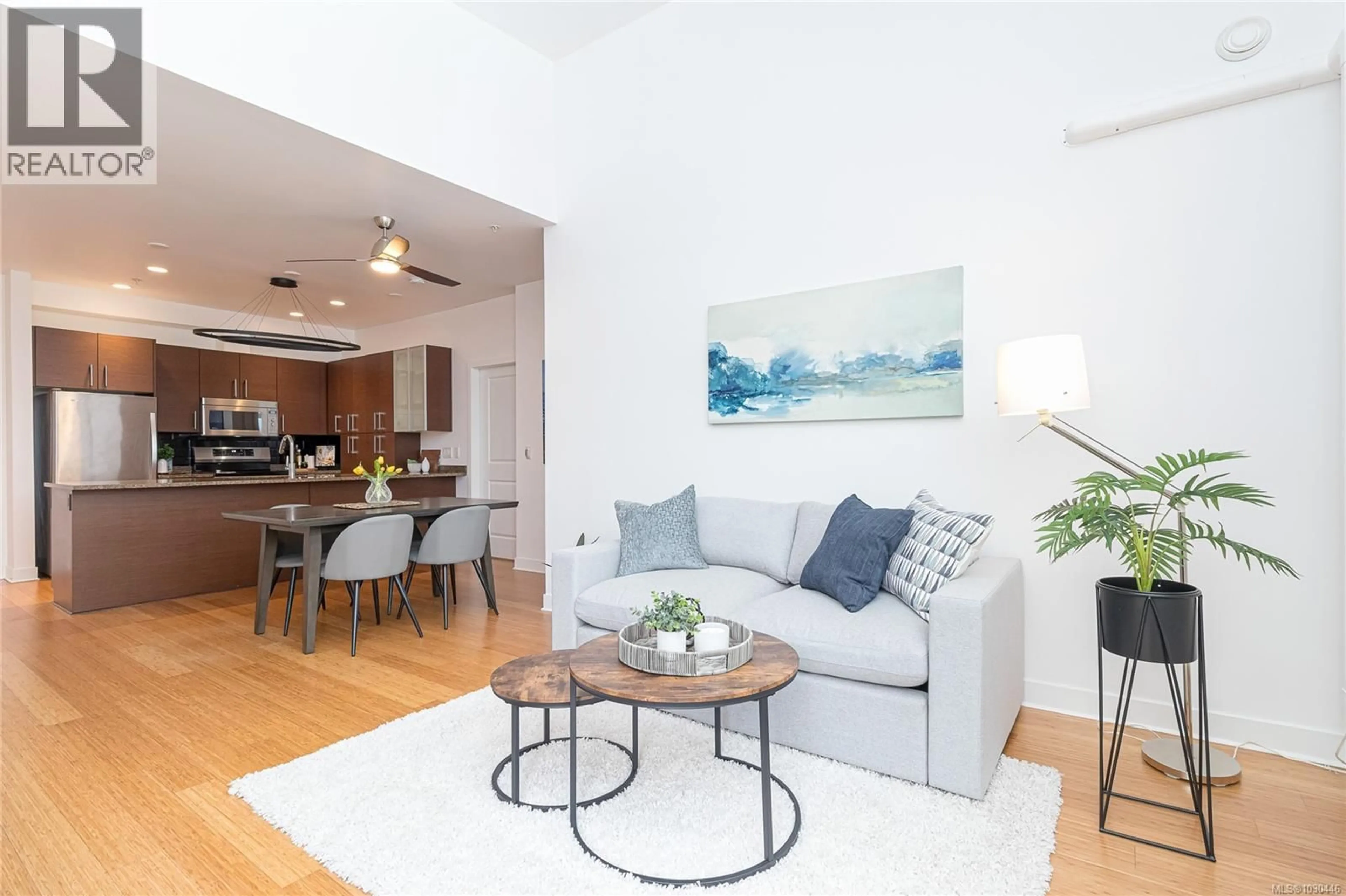 Living room with furniture, wood/laminate floor for 405 - 4394 WEST SAANICH ROAD, Saanich British Columbia V8Z3E9