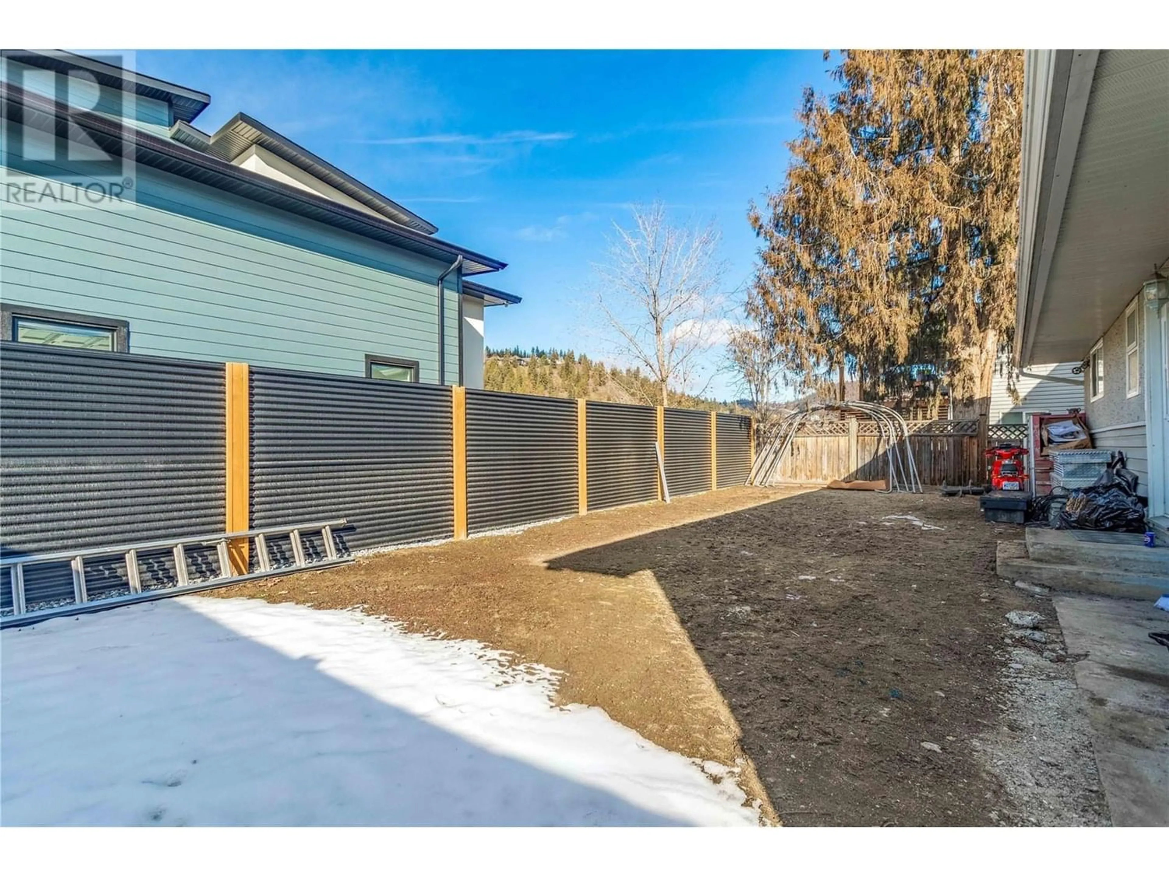 Frontside or backside of a home, the fenced backyard for 470 Snowsell Street N, Kelowna British Columbia V1V2C7