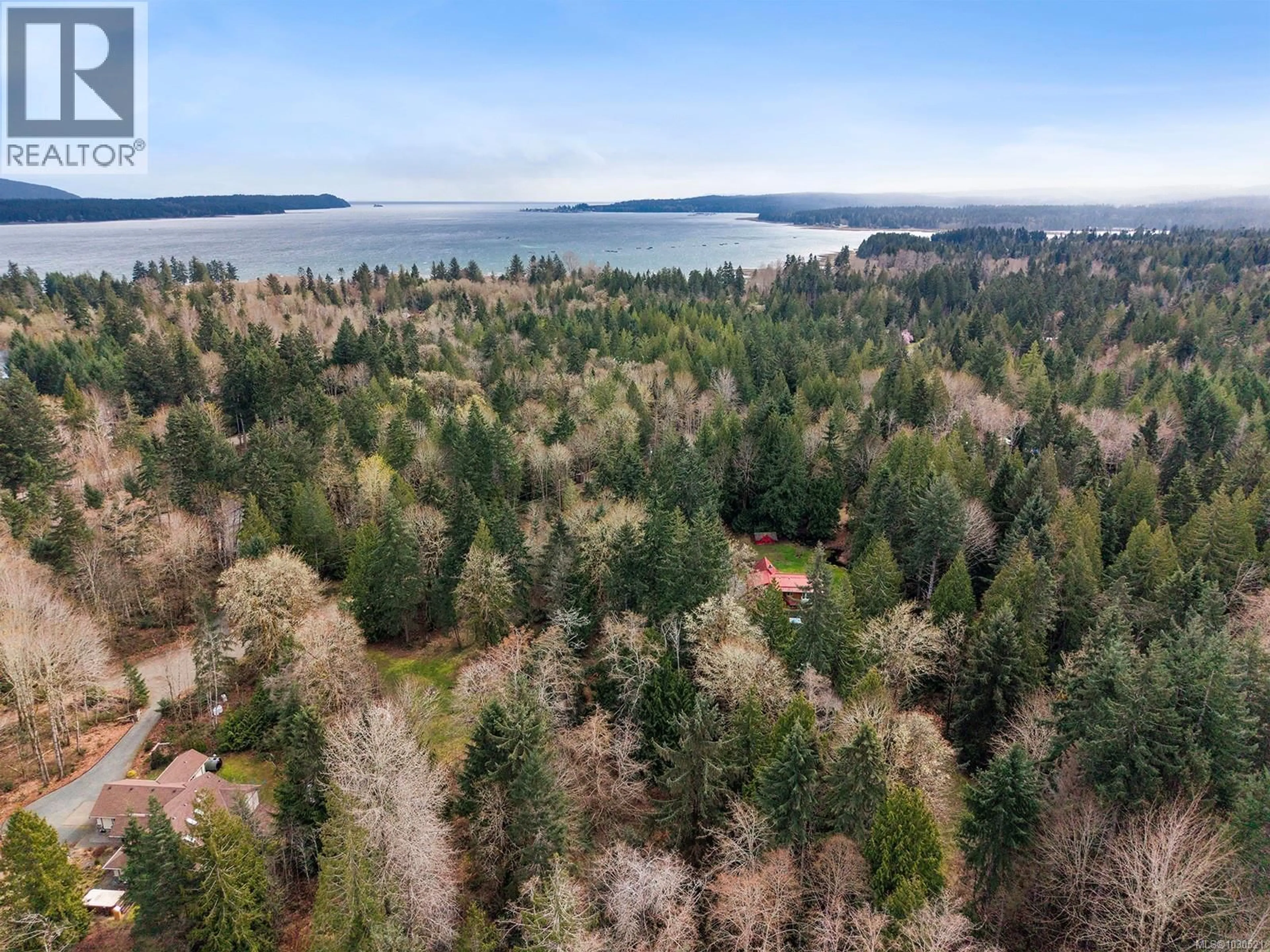 A pic from outside/outdoor area/front of a property/back of a property/a pic from drone, forest/trees view for 7889 MACARTNEY DRIVE, Fanny Bay British Columbia V0R1W0
