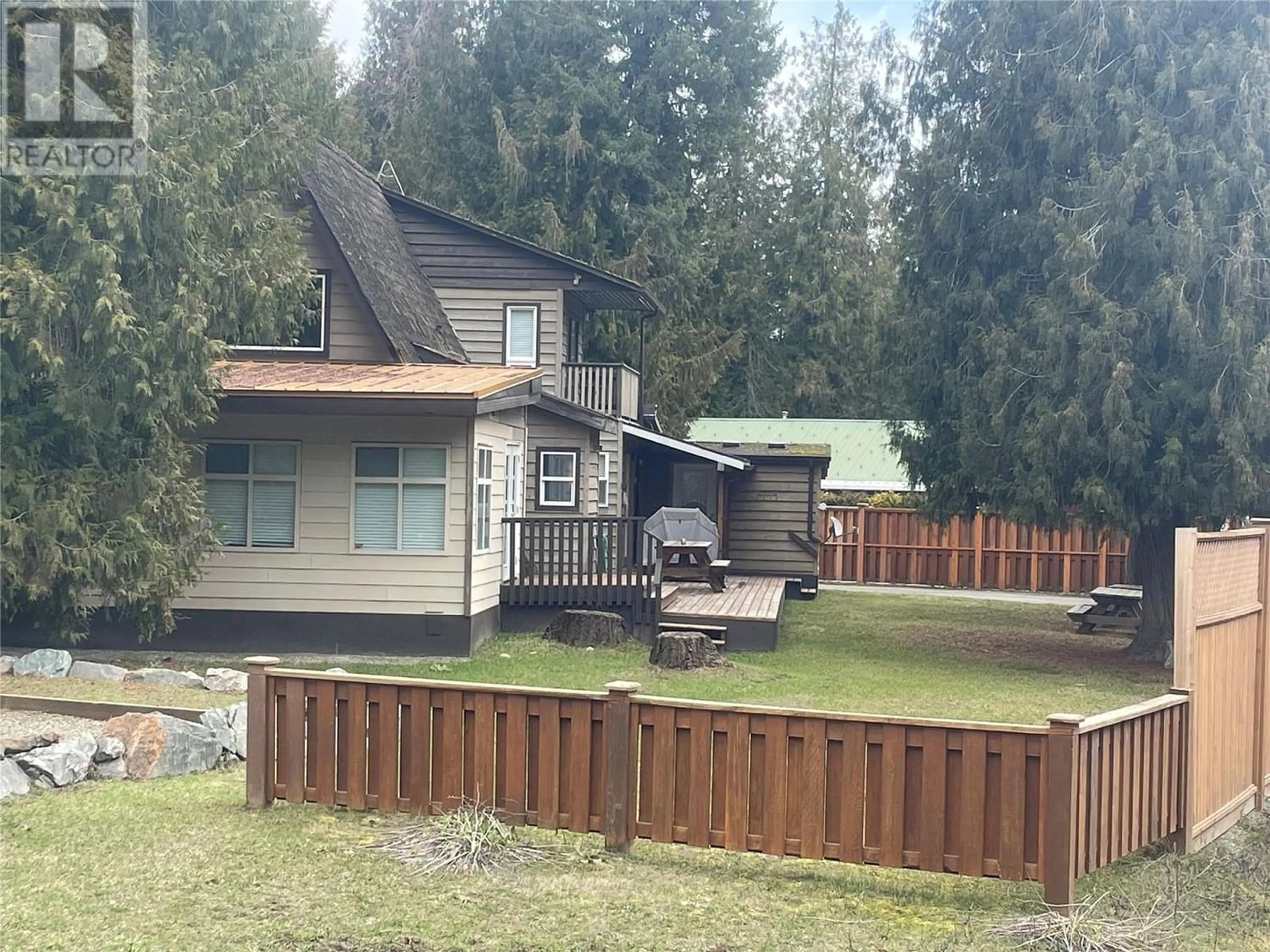 Frontside or backside of a home, the fenced backyard for 4025 Squilax-Anglemont Road, Scotch Creek British Columbia V0E1M5