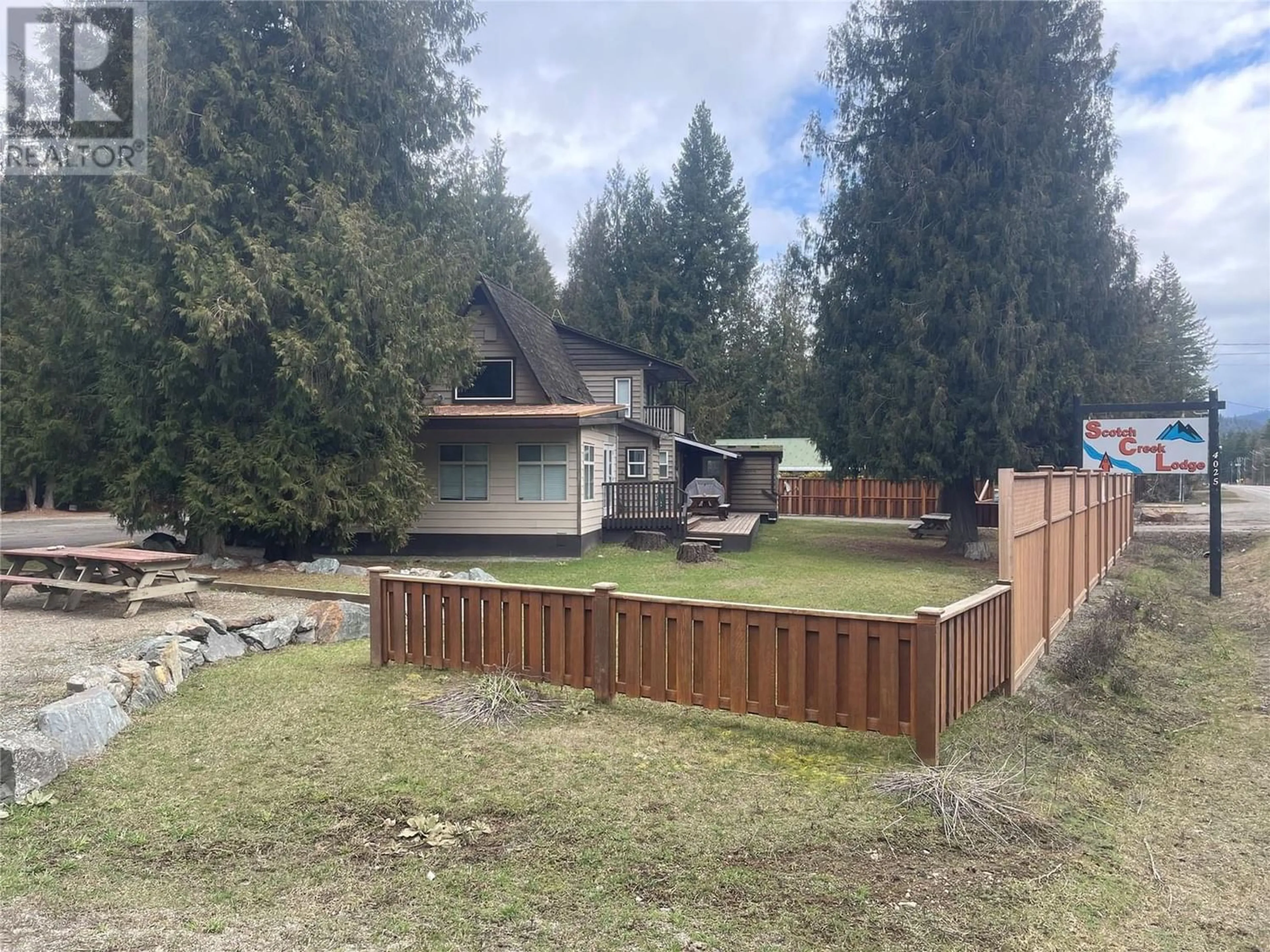 Frontside or backside of a home, the fenced backyard for 4025 Squilax-Anglemont Road, Scotch Creek British Columbia V0E1M5