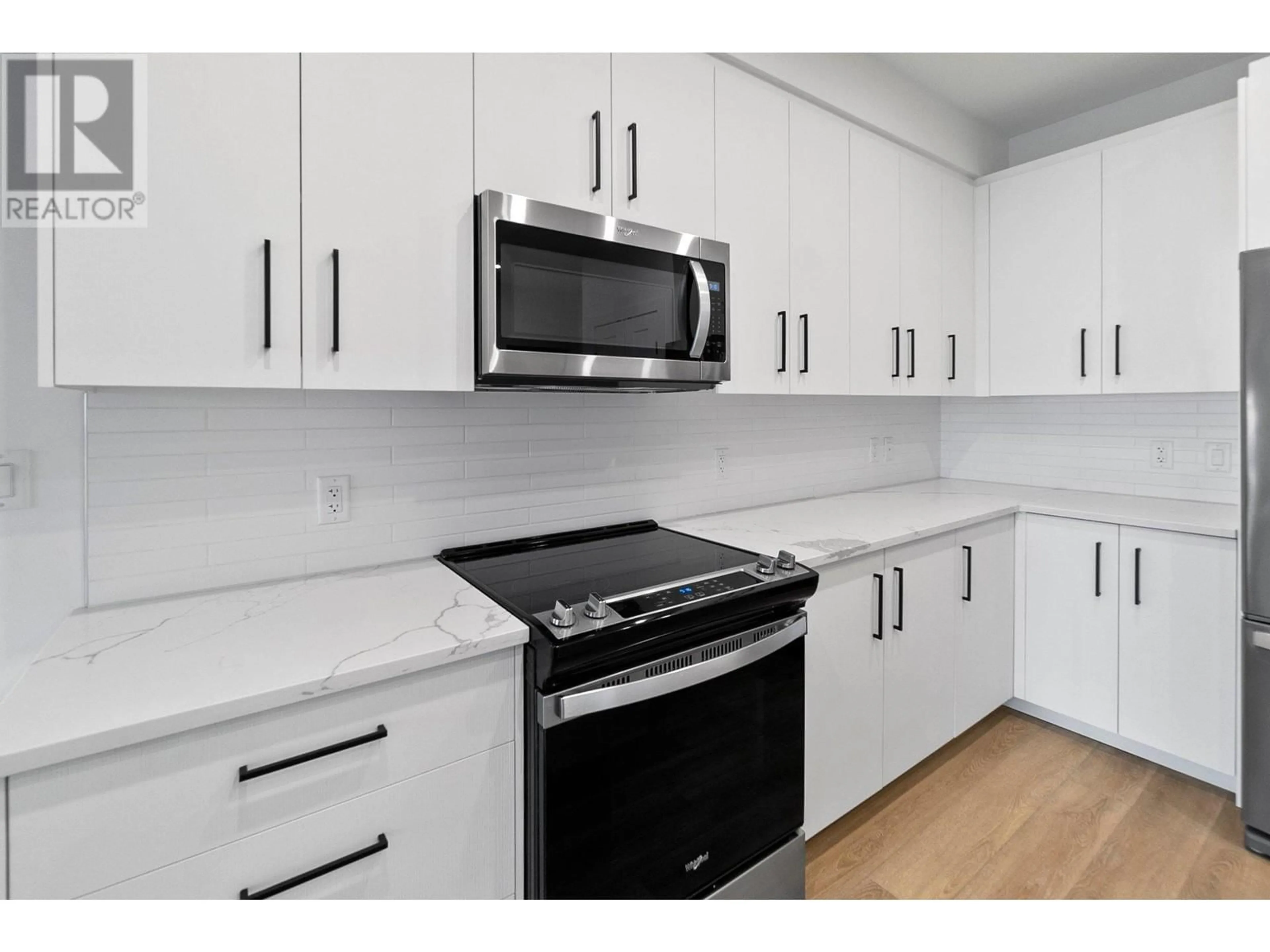 Standard kitchen, wood floors for 3434 Mckinley Beach Drive Unit# 108, Kelowna British Columbia V1V0H3