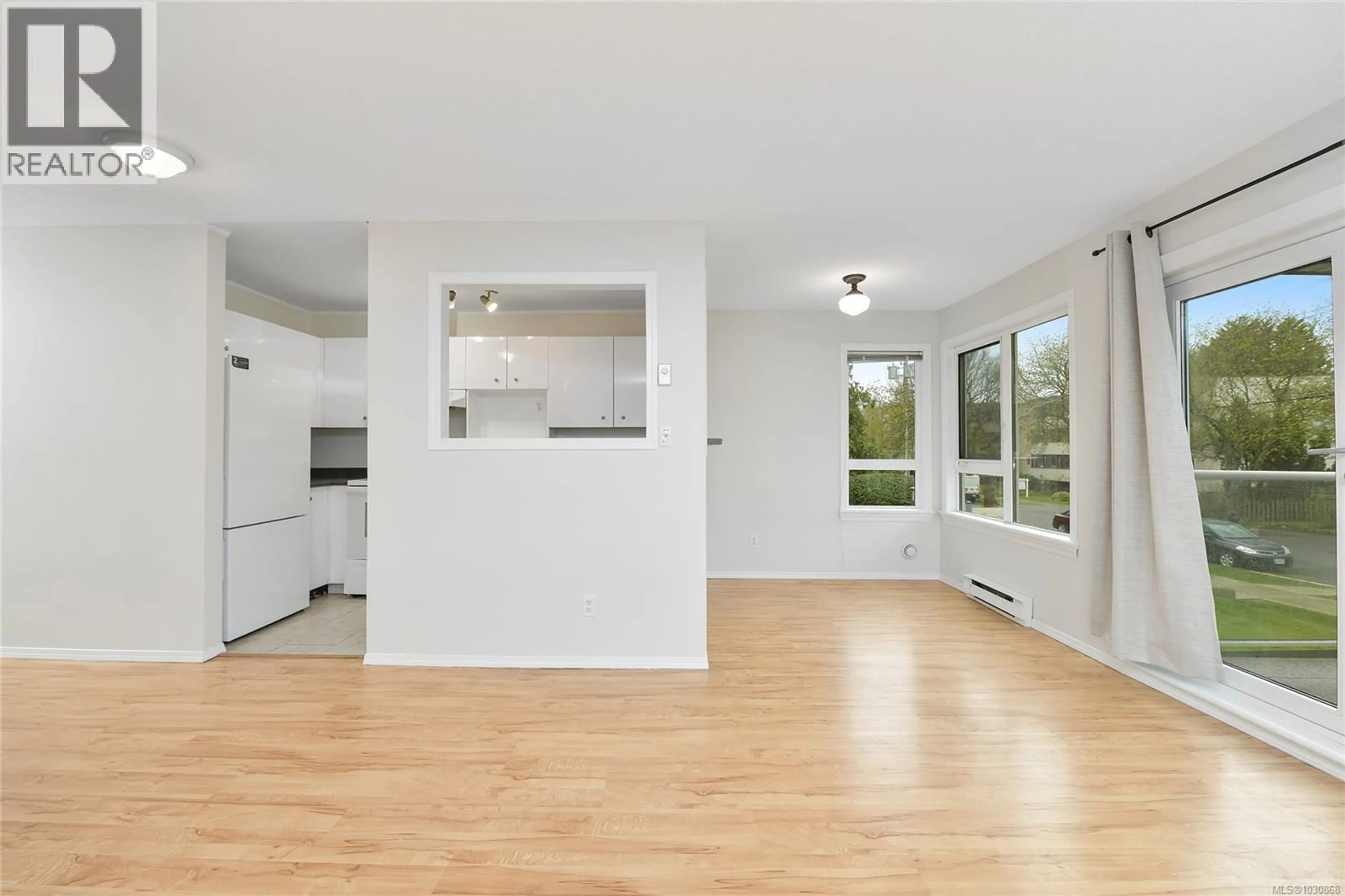 Open concept kitchen, wood/laminate floor for 202 - 2647 GRAHAM STREET, Victoria British Columbia V8T3Y8