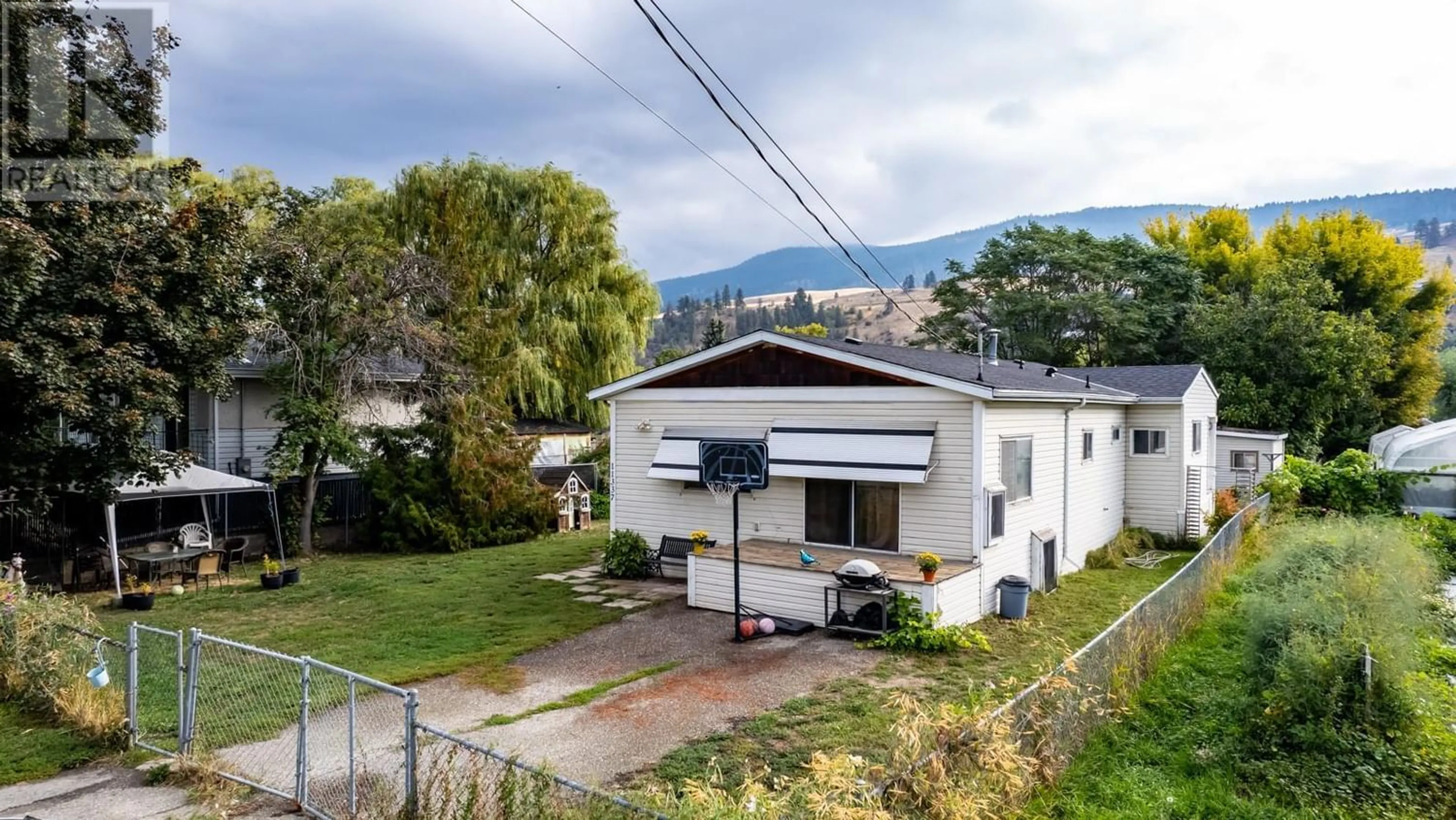 A pic from exterior of the house or condo, the fenced backyard for 11337 Reiswig Road, Lake Country British Columbia V4V1X5