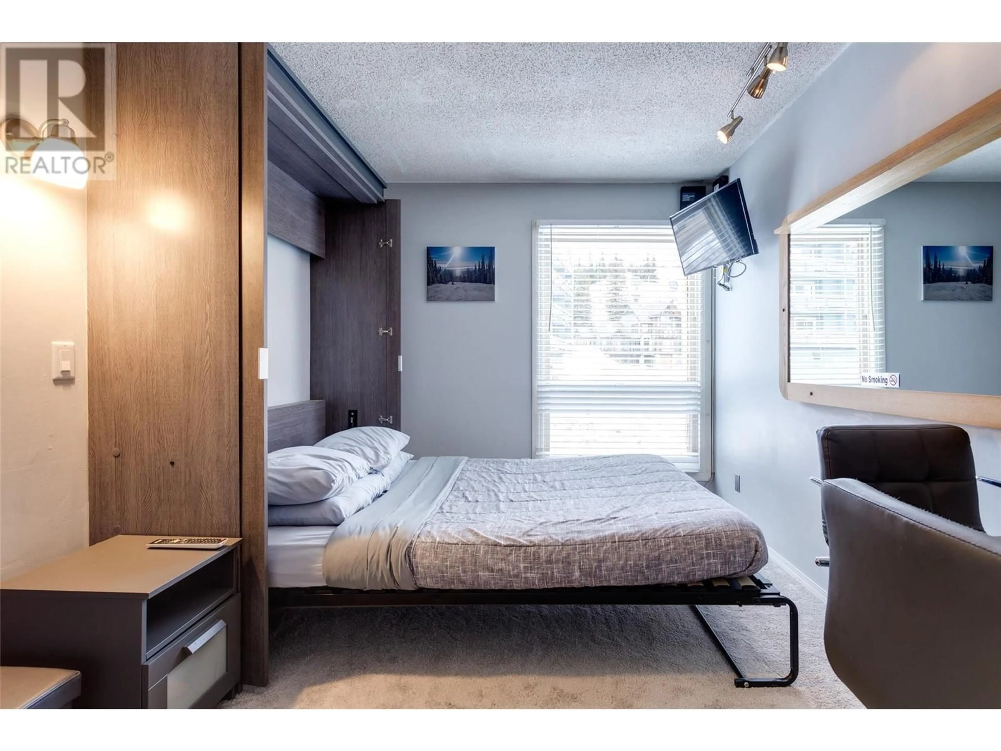 Bedroom with bed, wood/laminate floor for 230 - 5375 BIG WHITE ROAD, Big White British Columbia V1P1P3