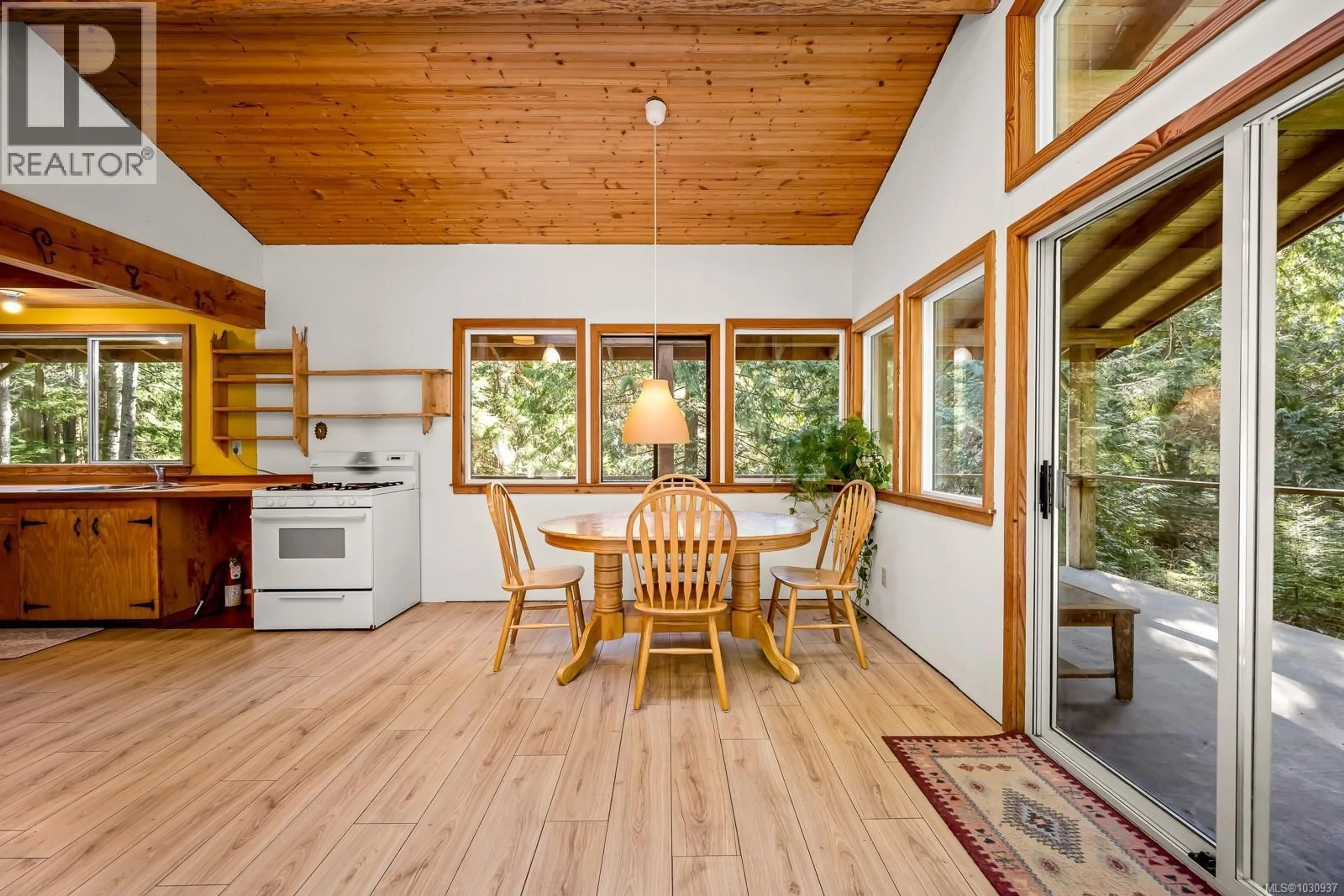 Open concept kitchen, wood/laminate floor for 421 WHALETOWN ROAD, Cortes Island British Columbia V0P1Z0