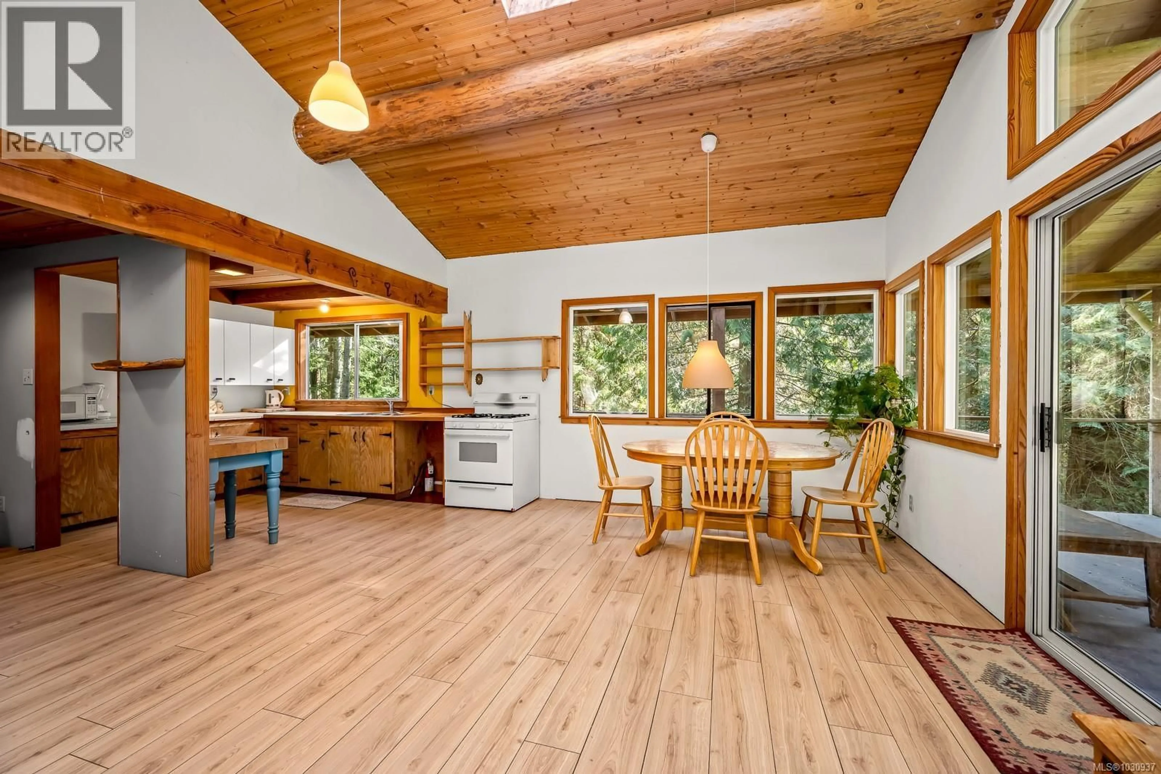 Open concept kitchen, wood/laminate floor for 421 WHALETOWN ROAD, Cortes Island British Columbia V0P1Z0
