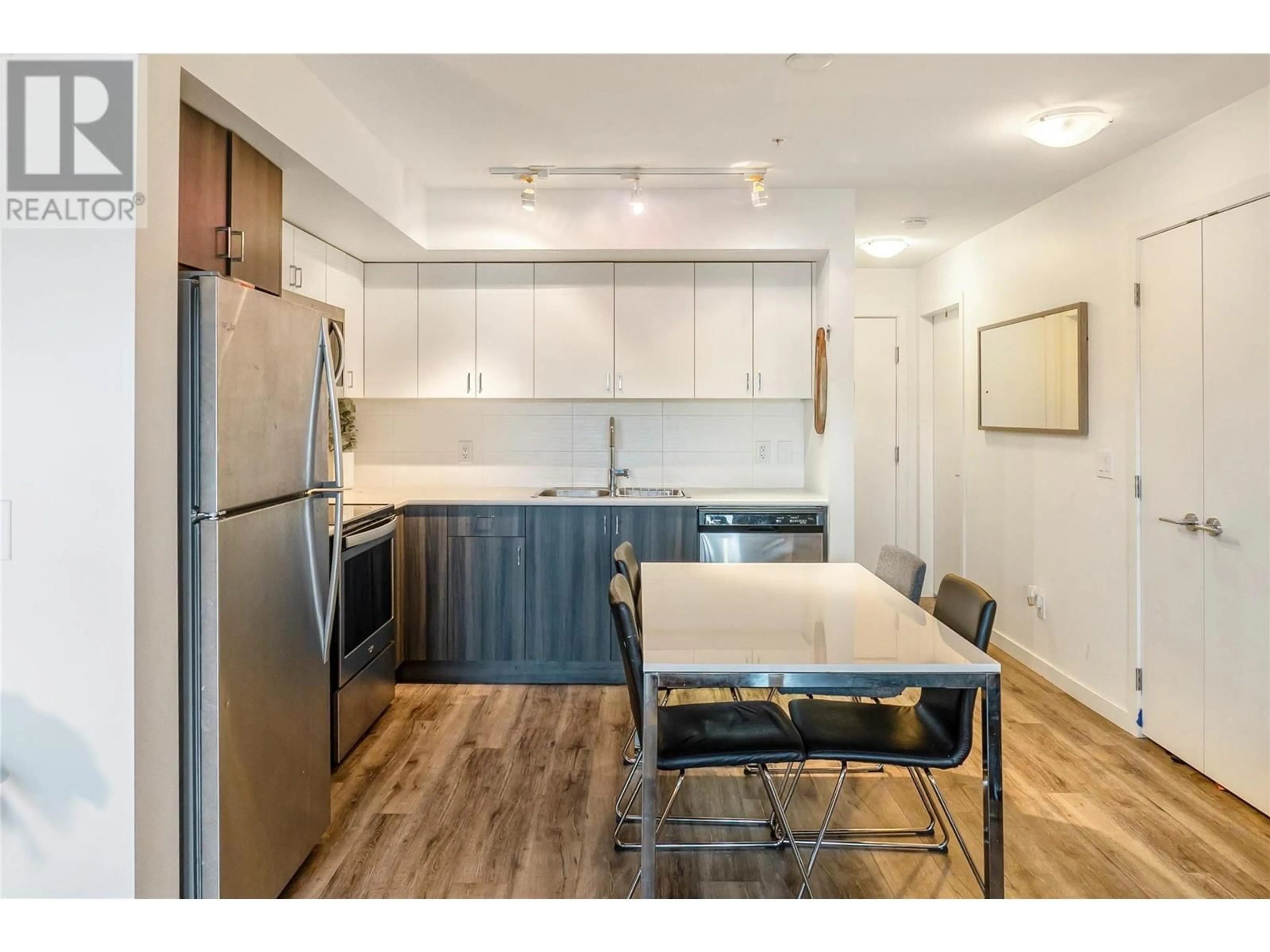 Open concept kitchen, wood/laminate floor for 121 - 655 ACADEMY WAY, Kelowna British Columbia V1V0A2