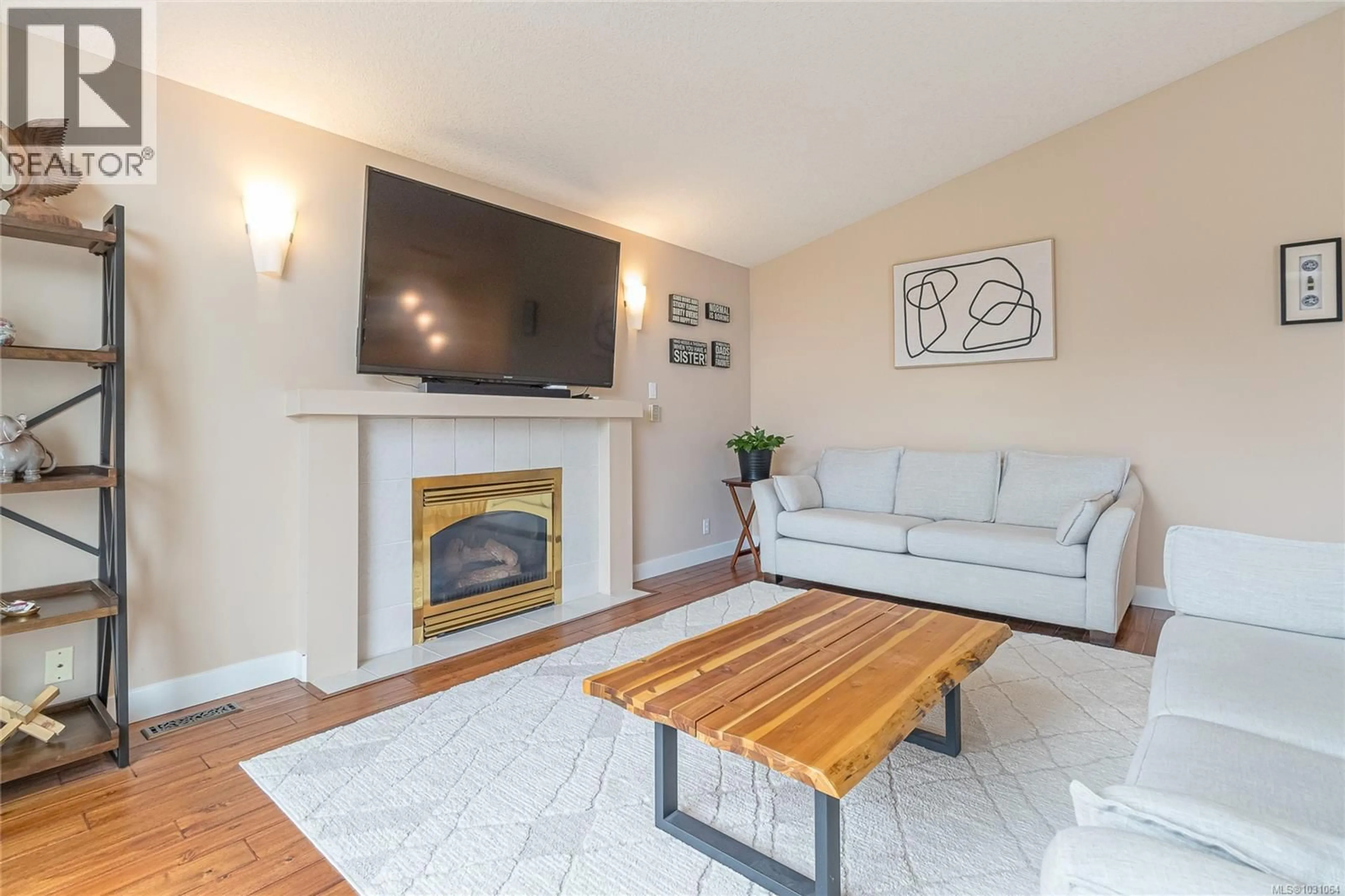 Living room with furniture, wood/laminate floor for 6375 LASALLE ROAD, Nanaimo British Columbia V9V1N6