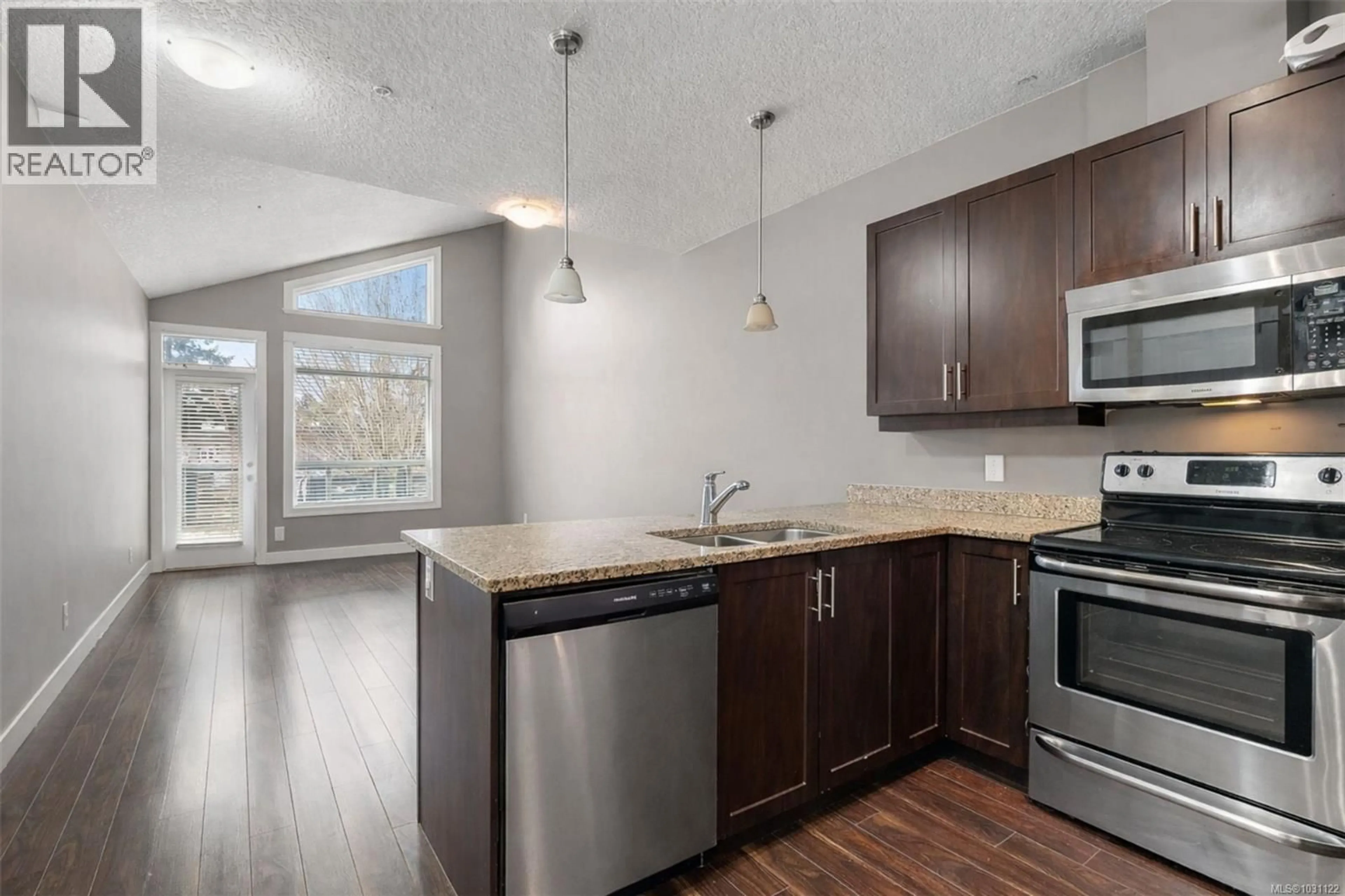 Open concept kitchen, wood/laminate floor for 305 - 938 DUNFORD AVENUE, Langford British Columbia V9B0M2