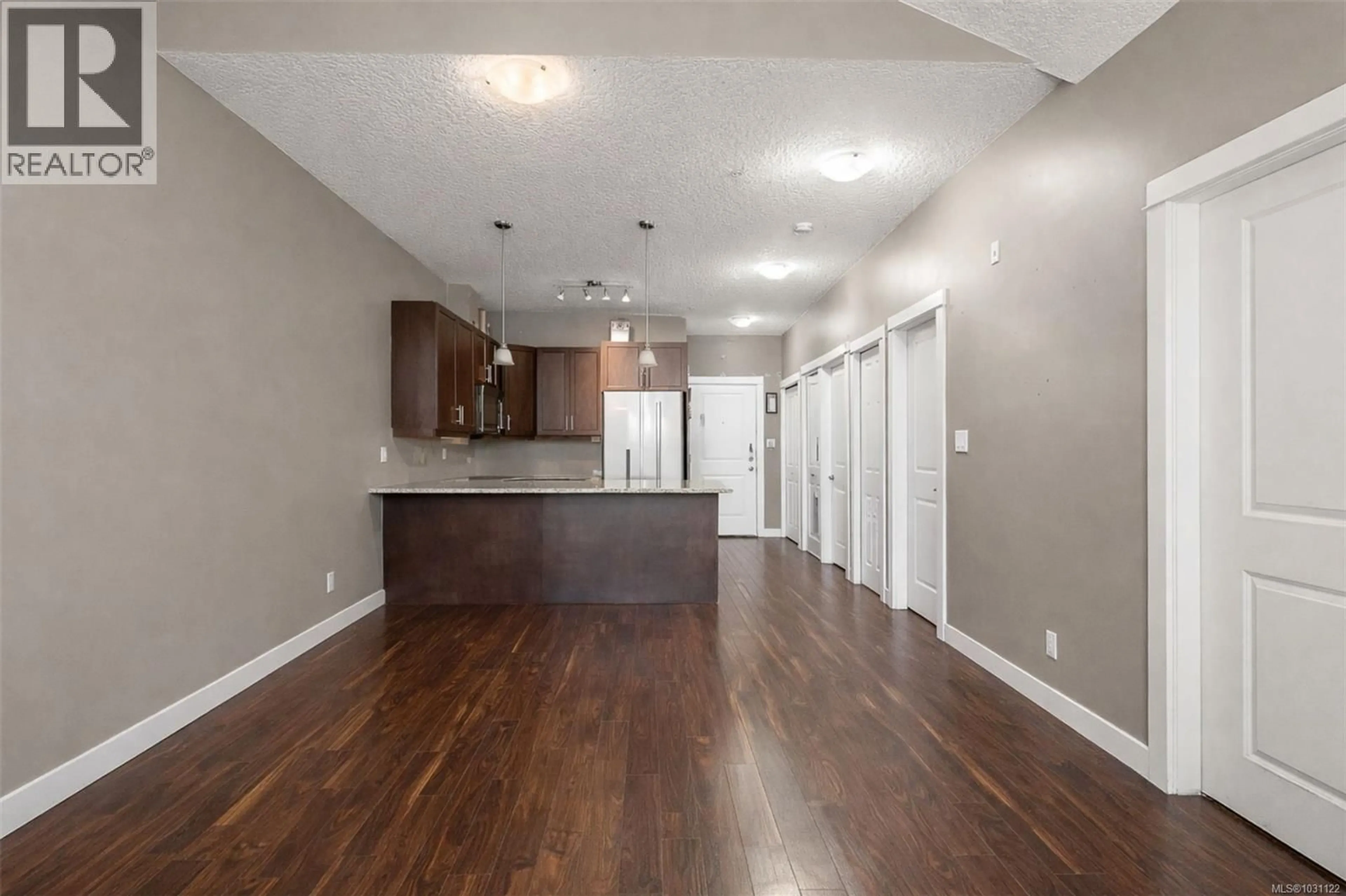 Open concept kitchen, wood/laminate floor for 305 - 938 DUNFORD AVENUE, Langford British Columbia V9B0M2