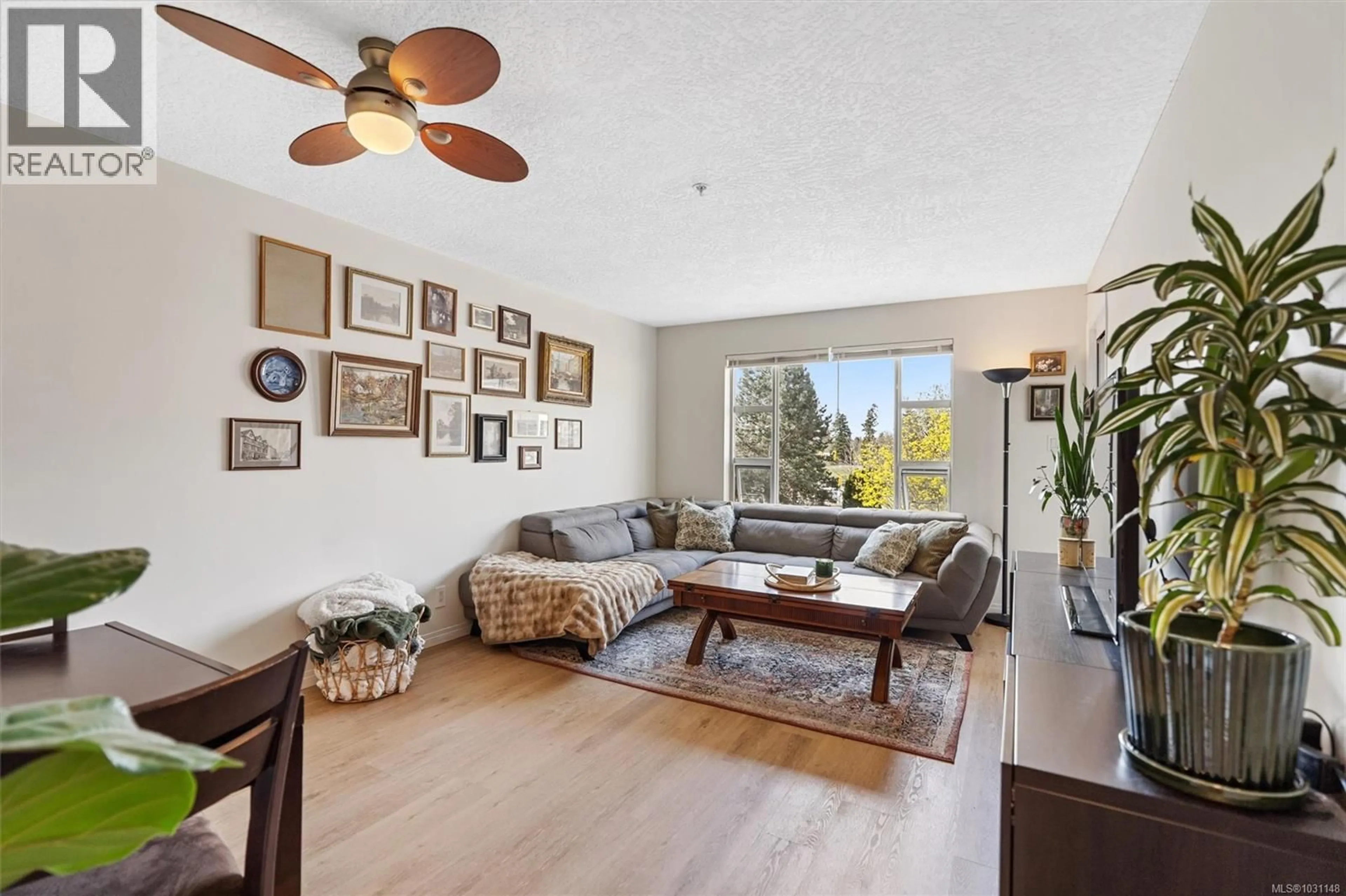 Living room with furniture, wood/laminate floor for 210 - 799 BLACKBERRY ROAD, Saanich British Columbia V8X5J3