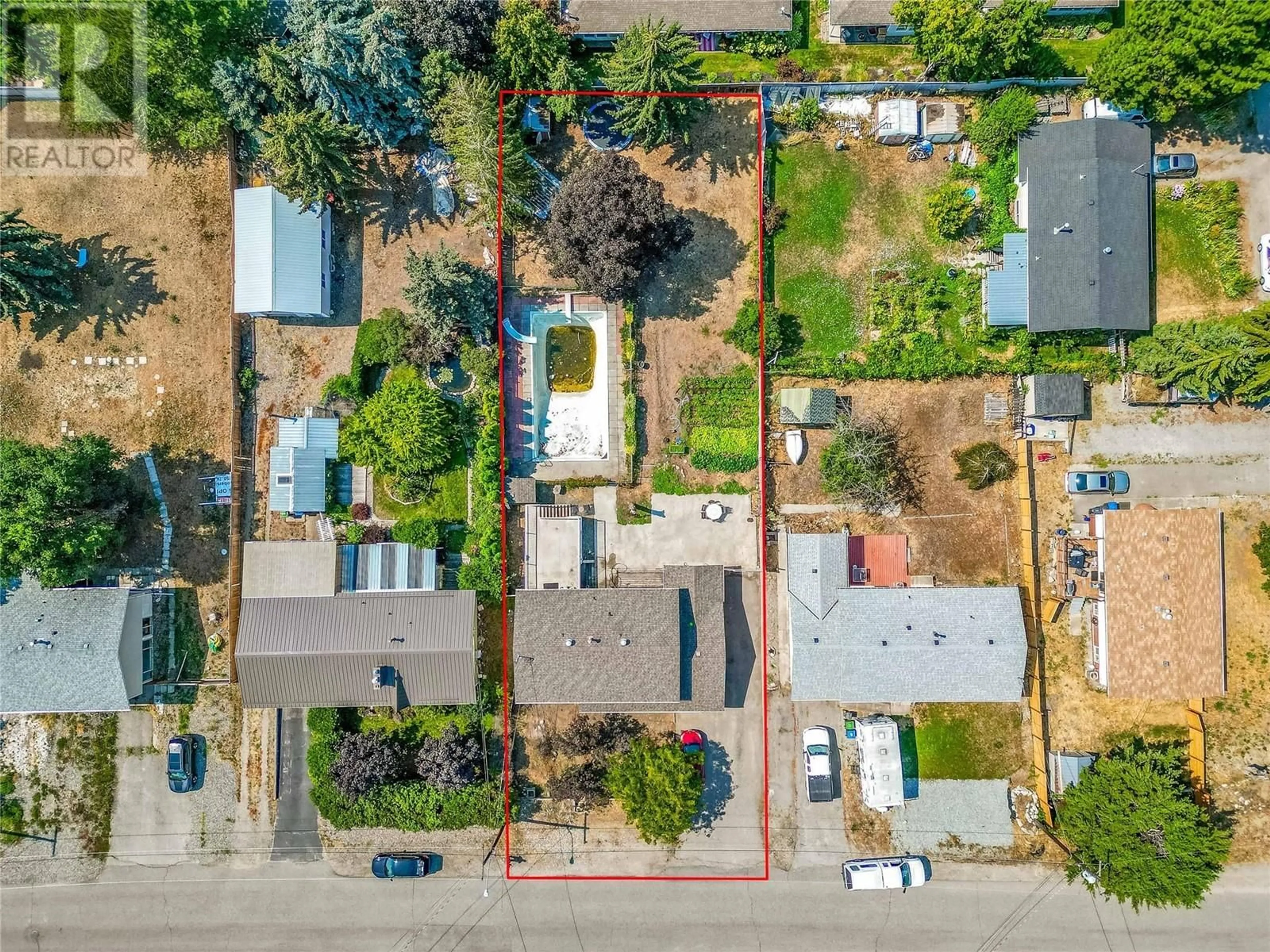 Frontside or backside of a home, the fenced backyard for 200 Dundas Road, Kelowna British Columbia V1X3X7