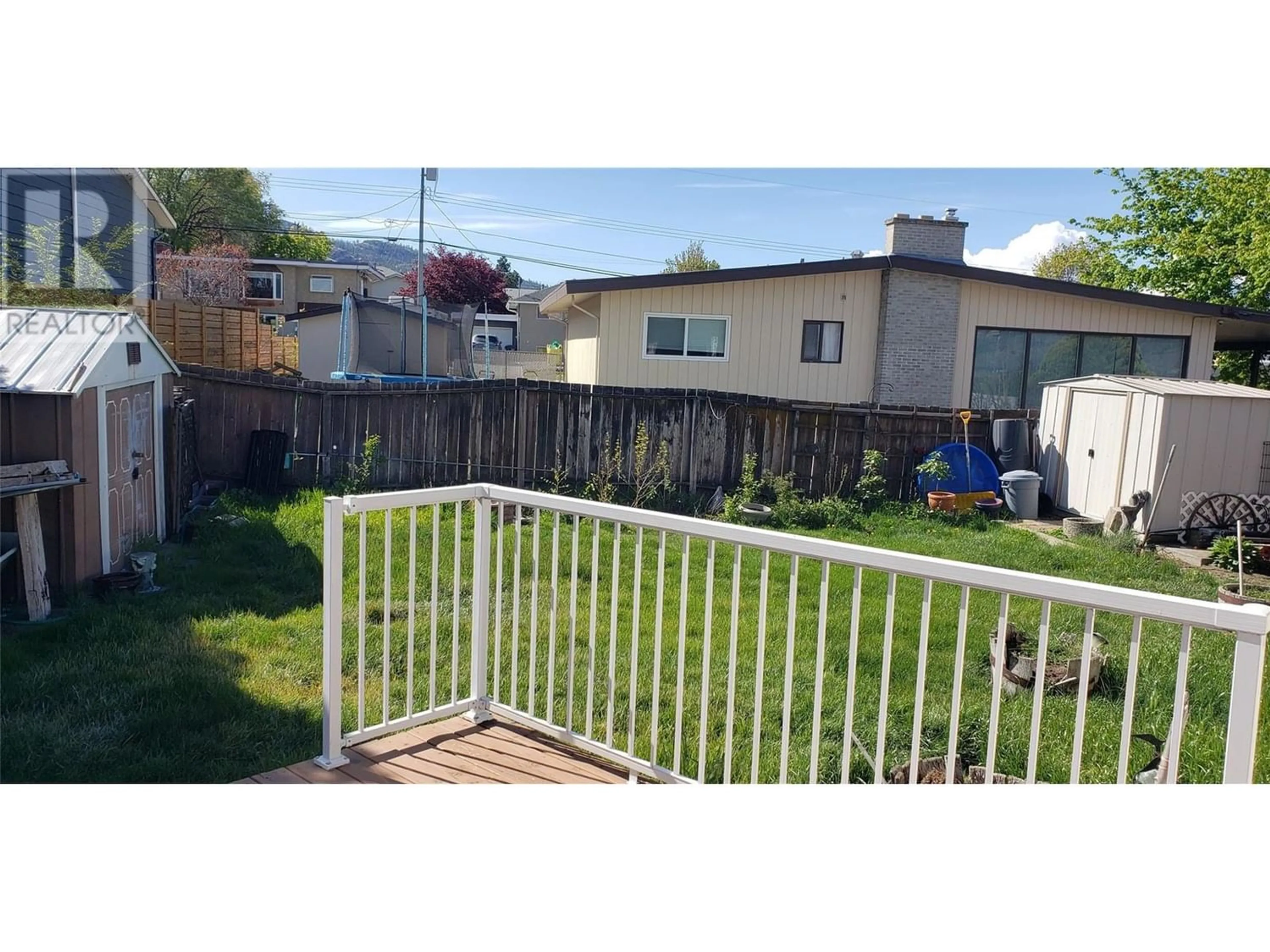 Frontside or backside of a home, the fenced backyard for 1428 Dartmouth Street Street, Penticton British Columbia V2A4B4