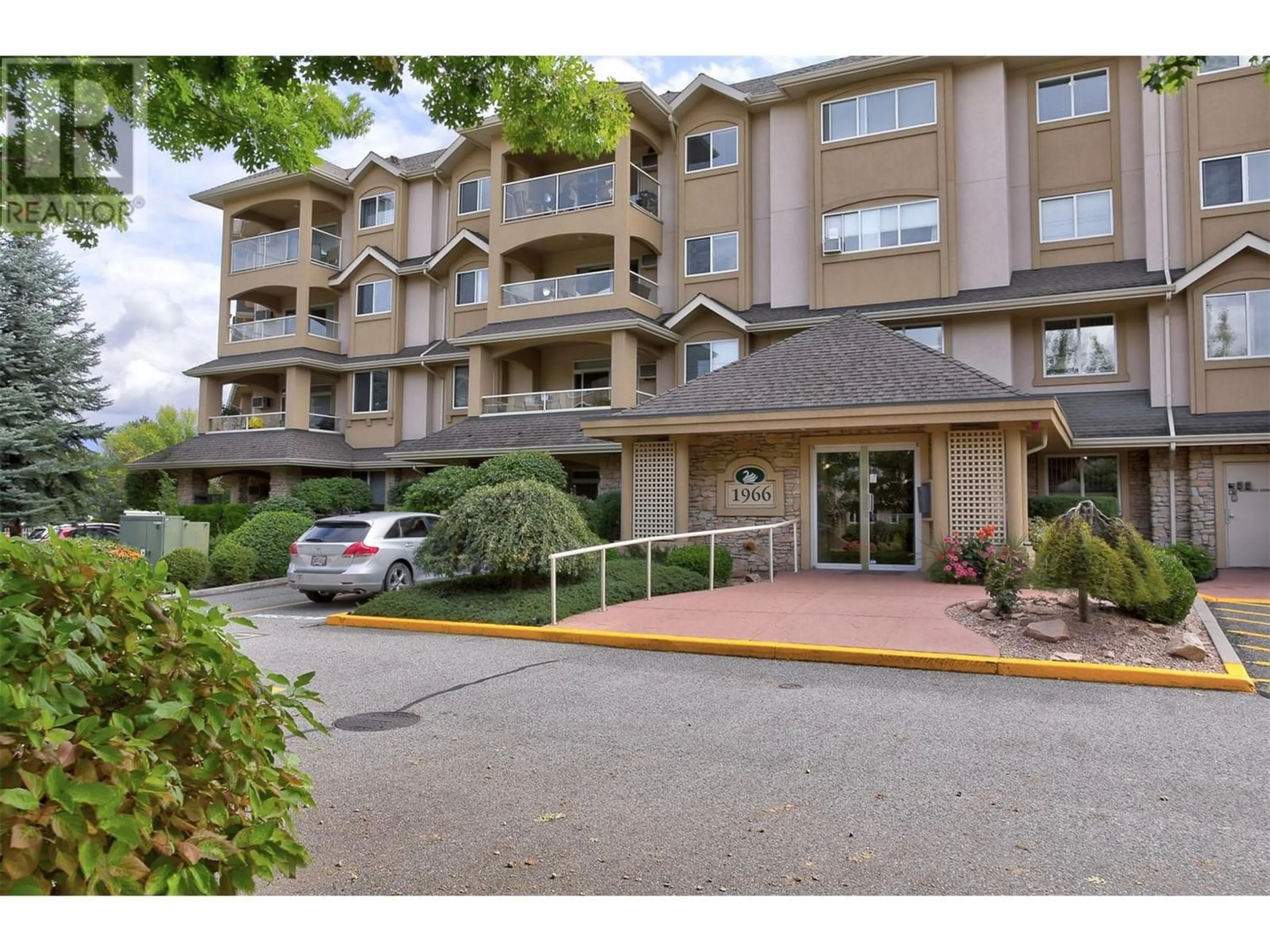 A pic from exterior of the house or condo for 1966 Enterprise Way Unit# 104, Kelowna British Columbia V1Y9S8