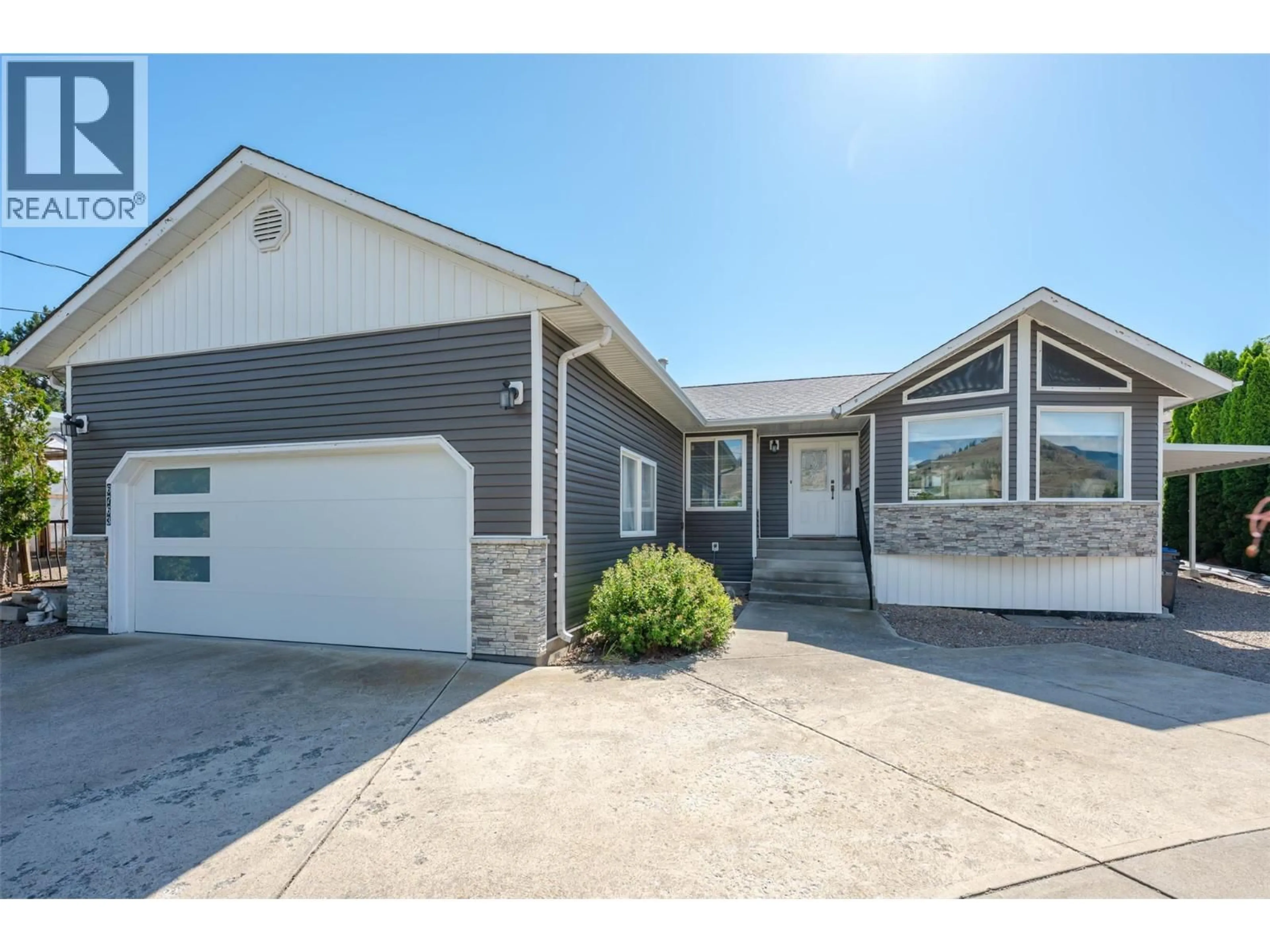 Home with vinyl exterior material, street for 6763 MEADOWS DRIVE, Oliver British Columbia V0H1T4