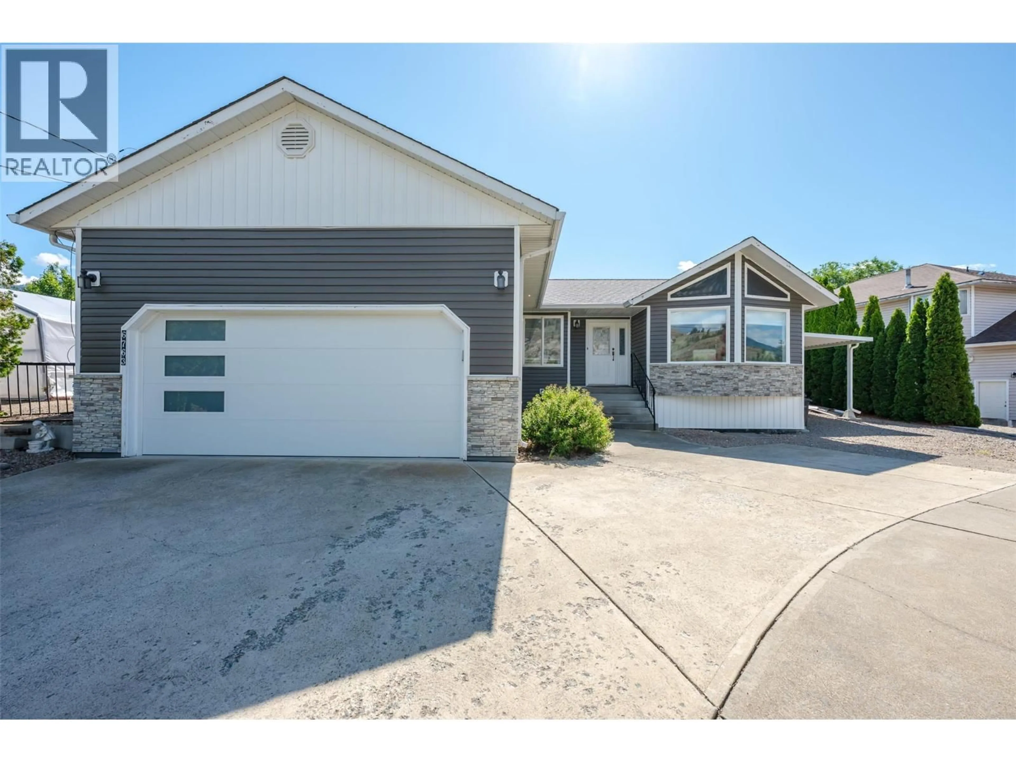 Home with vinyl exterior material, street for 6763 MEADOWS DRIVE, Oliver British Columbia V0H1T4