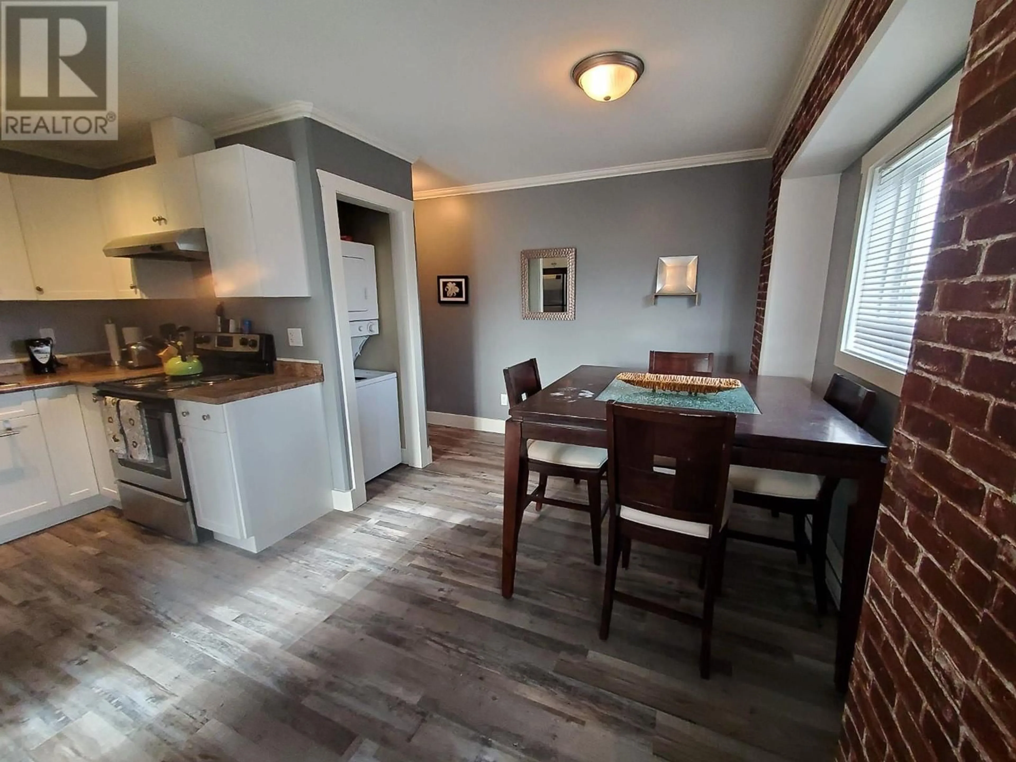 Open concept kitchen, wood/laminate floor for 113 - 10209 17 STREET, Dawson Creek British Columbia V1G4C3