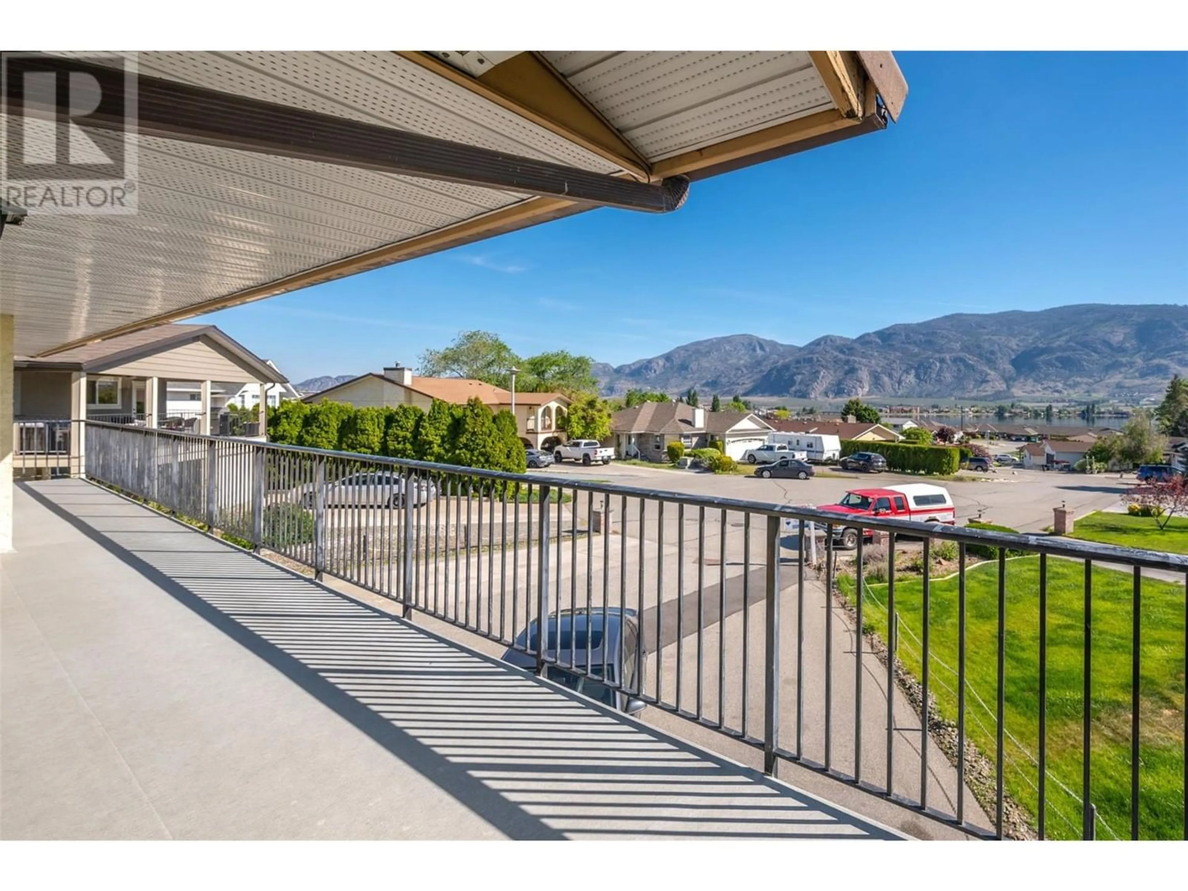 A pic from exterior of the house or condo, the fenced backyard for 18 HEATHER Place, Osoyoos British Columbia V0H1V1