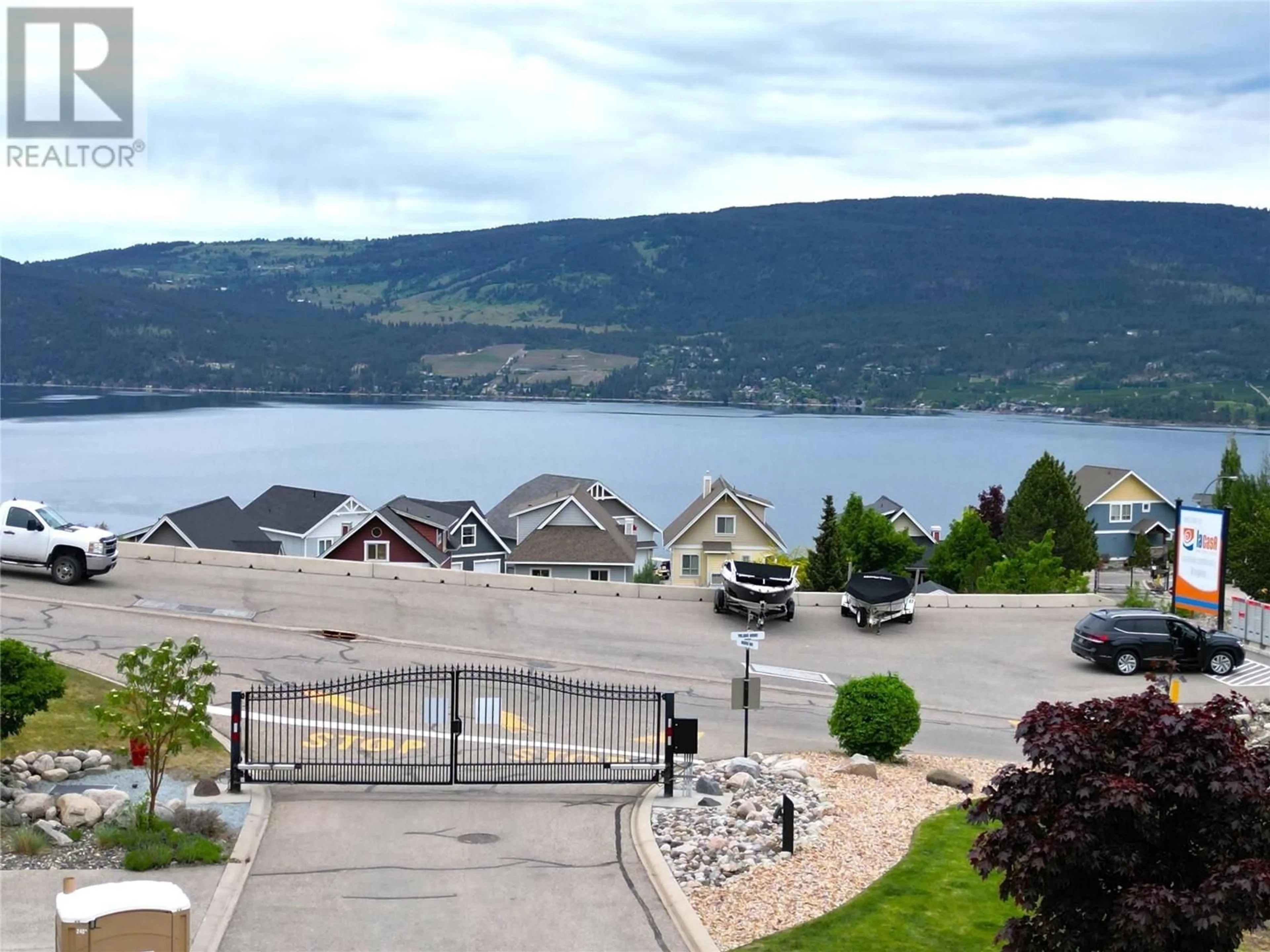 A pic from outside/outdoor area/front of a property/back of a property/a pic from drone, water/lake/river/ocean view for 6862 MADRID WAY, Kelowna British Columbia V1Z3R8