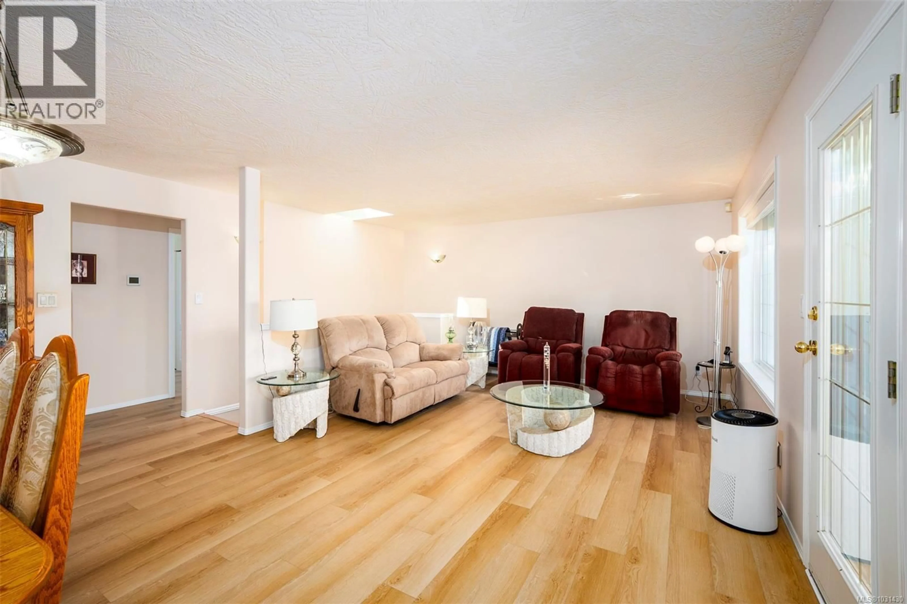 Living room with furniture, wood/laminate floor for 4749 HAMMOND BAY ROAD, Nanaimo British Columbia V9T5A9