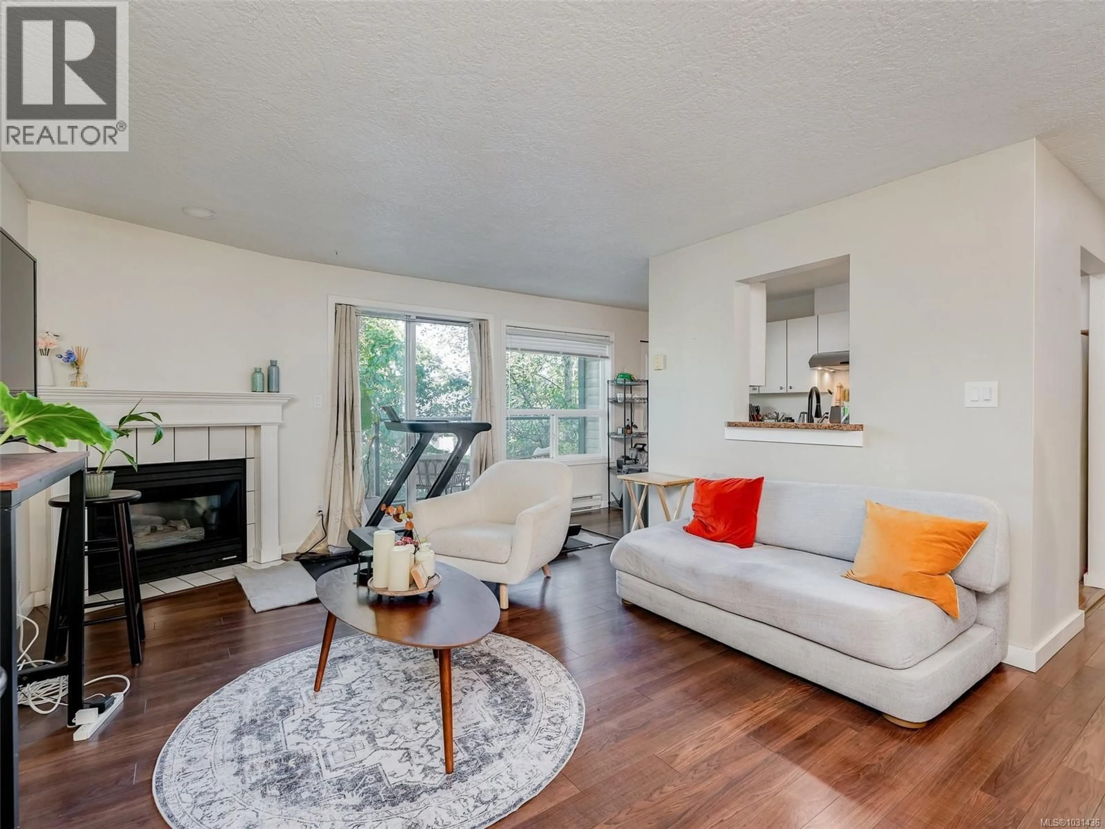 Living room with furniture, wood/laminate floor for 308 - 899 DARWIN AVENUE, Saanich British Columbia V8X2X7