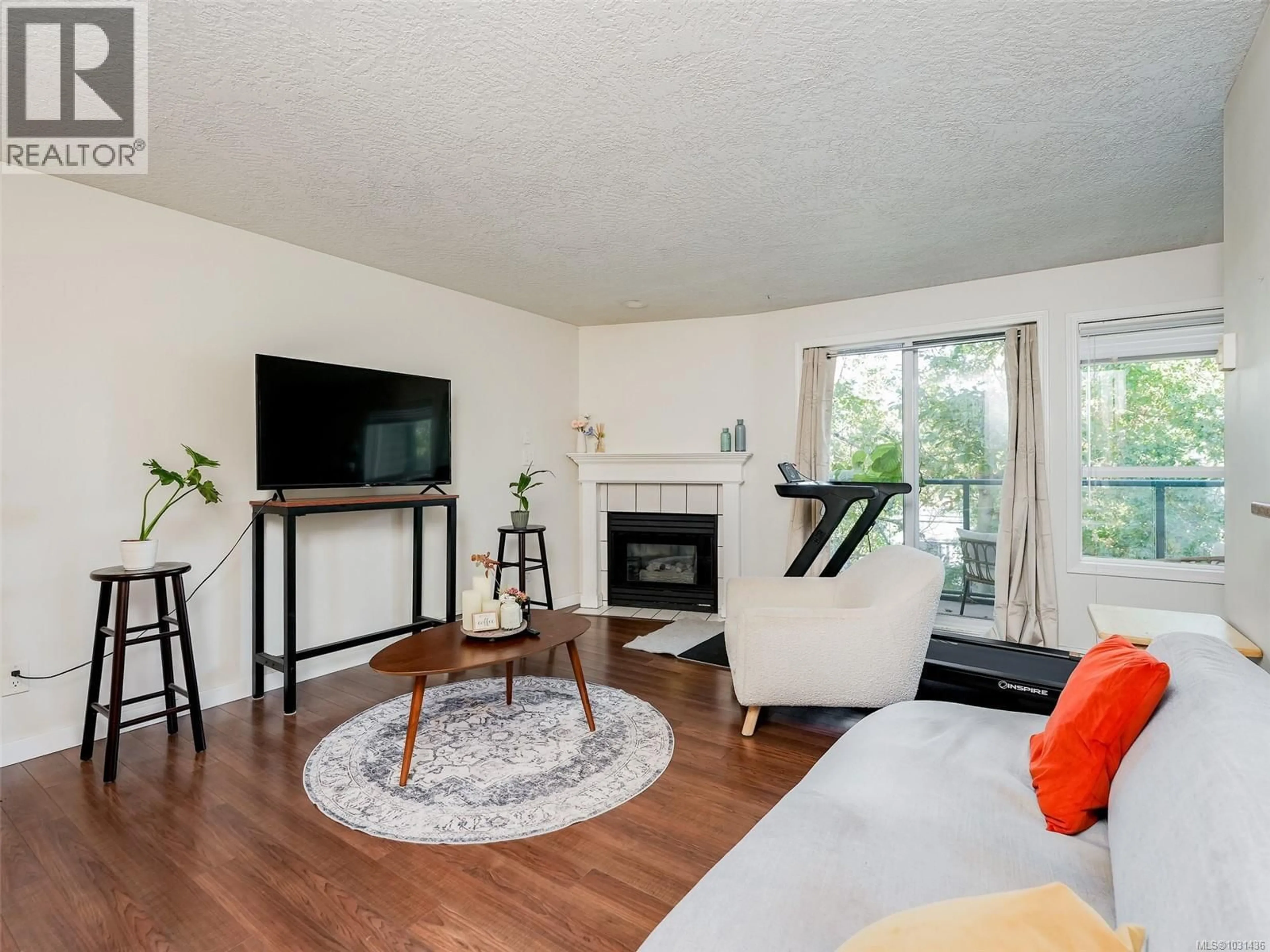 Living room with furniture, wood/laminate floor for 308 - 899 DARWIN AVENUE, Saanich British Columbia V8X2X7