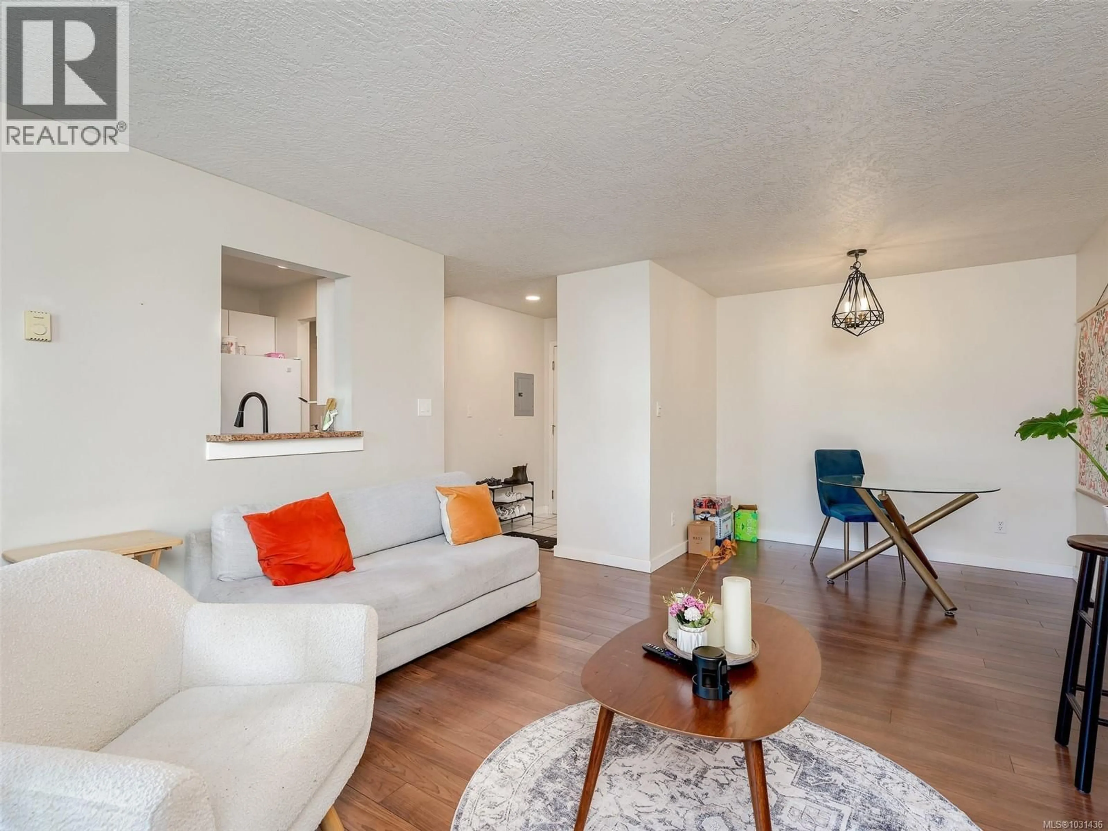 Living room with furniture, wood/laminate floor for 308 - 899 DARWIN AVENUE, Saanich British Columbia V8X2X7