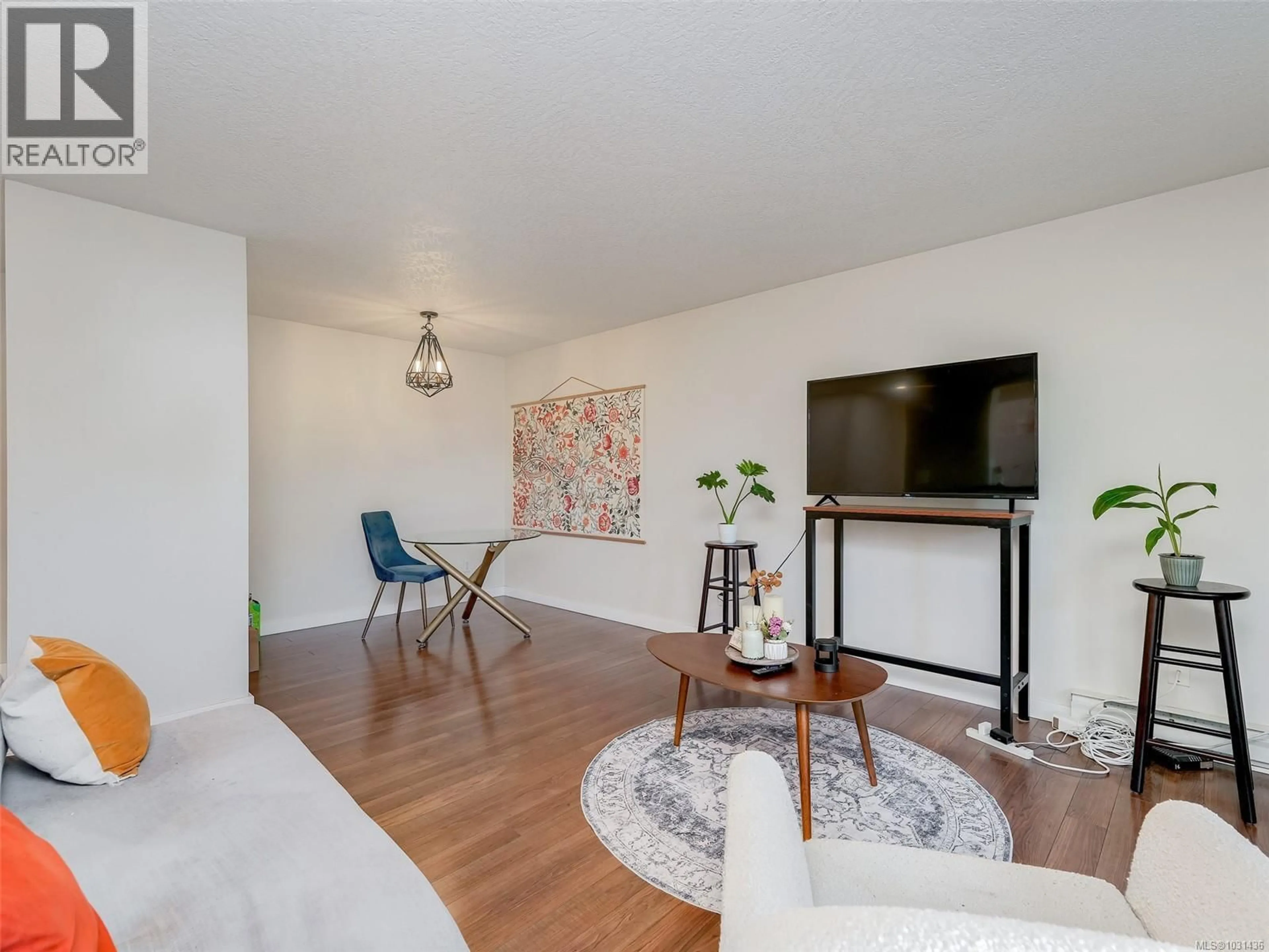 Living room with furniture, wood/laminate floor for 308 - 899 DARWIN AVENUE, Saanich British Columbia V8X2X7
