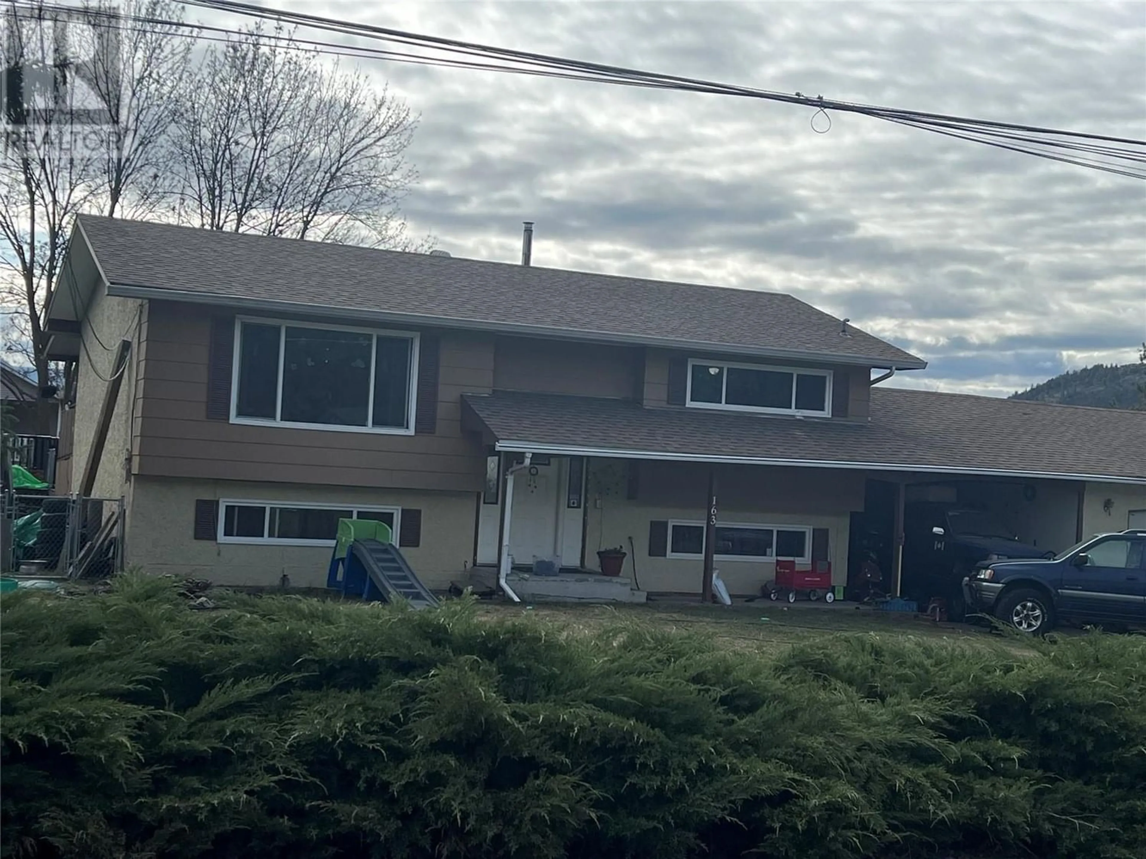 Frontside or backside of a home for 163 Cariboo Road, Kelowna British Columbia V1V2E4