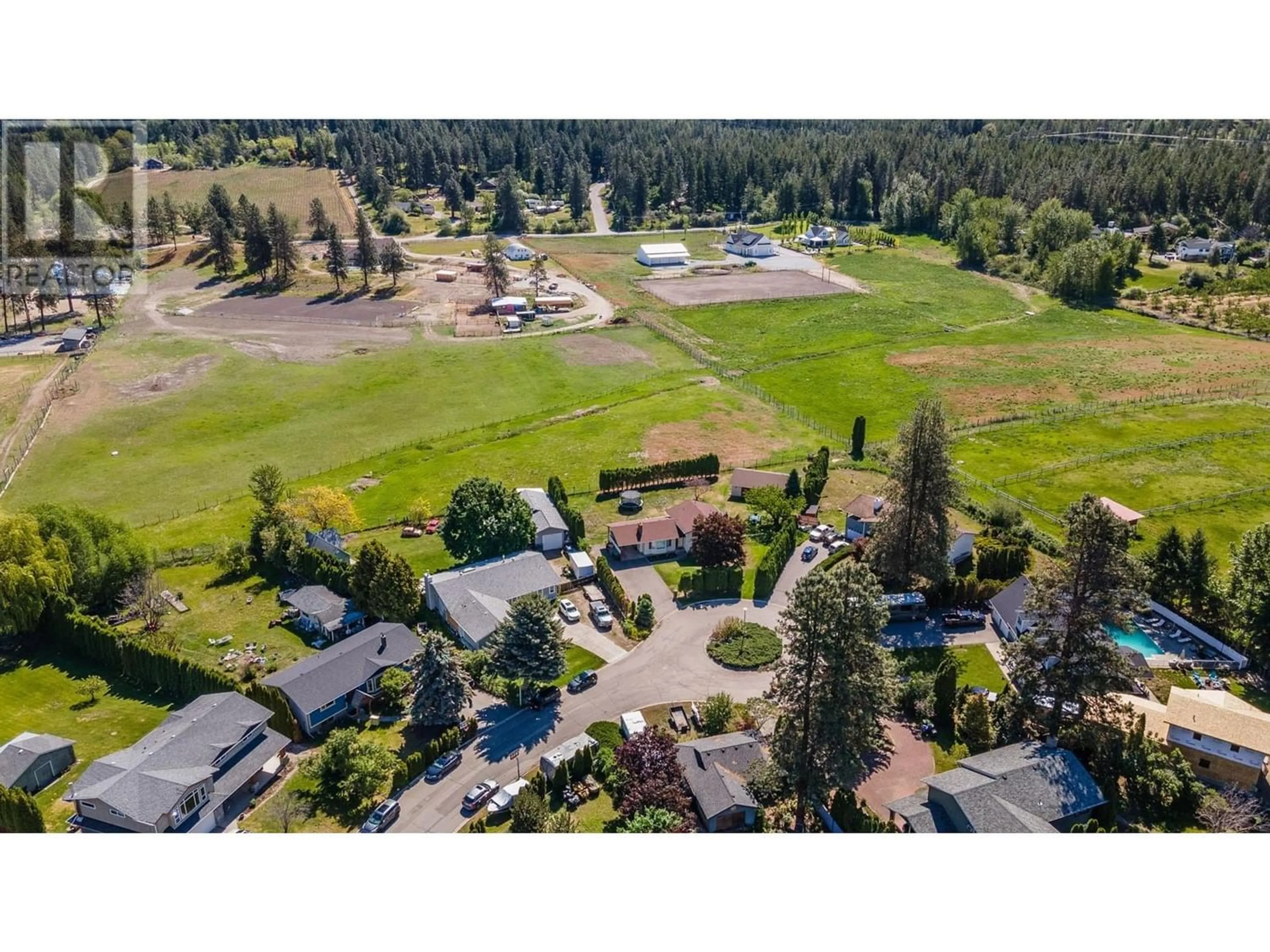 A pic from exterior of the house or condo, the fenced backyard for 2160 Diamond Road, Kelowna British Columbia V1W4B9