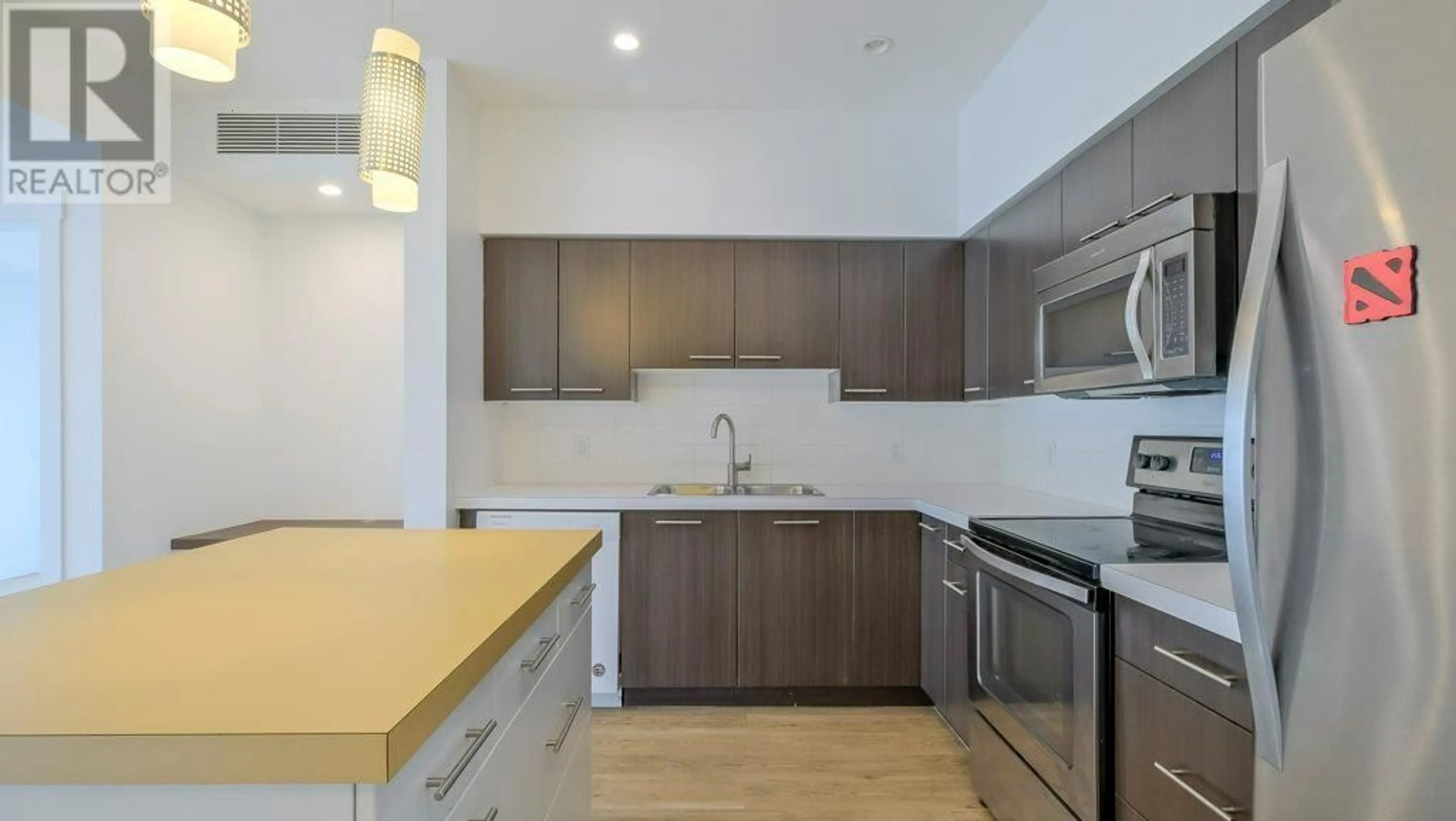 Standard kitchen, wood/laminate floor for 101 - 985 ACADEMY WAY, Kelowna British Columbia V1V3C8
