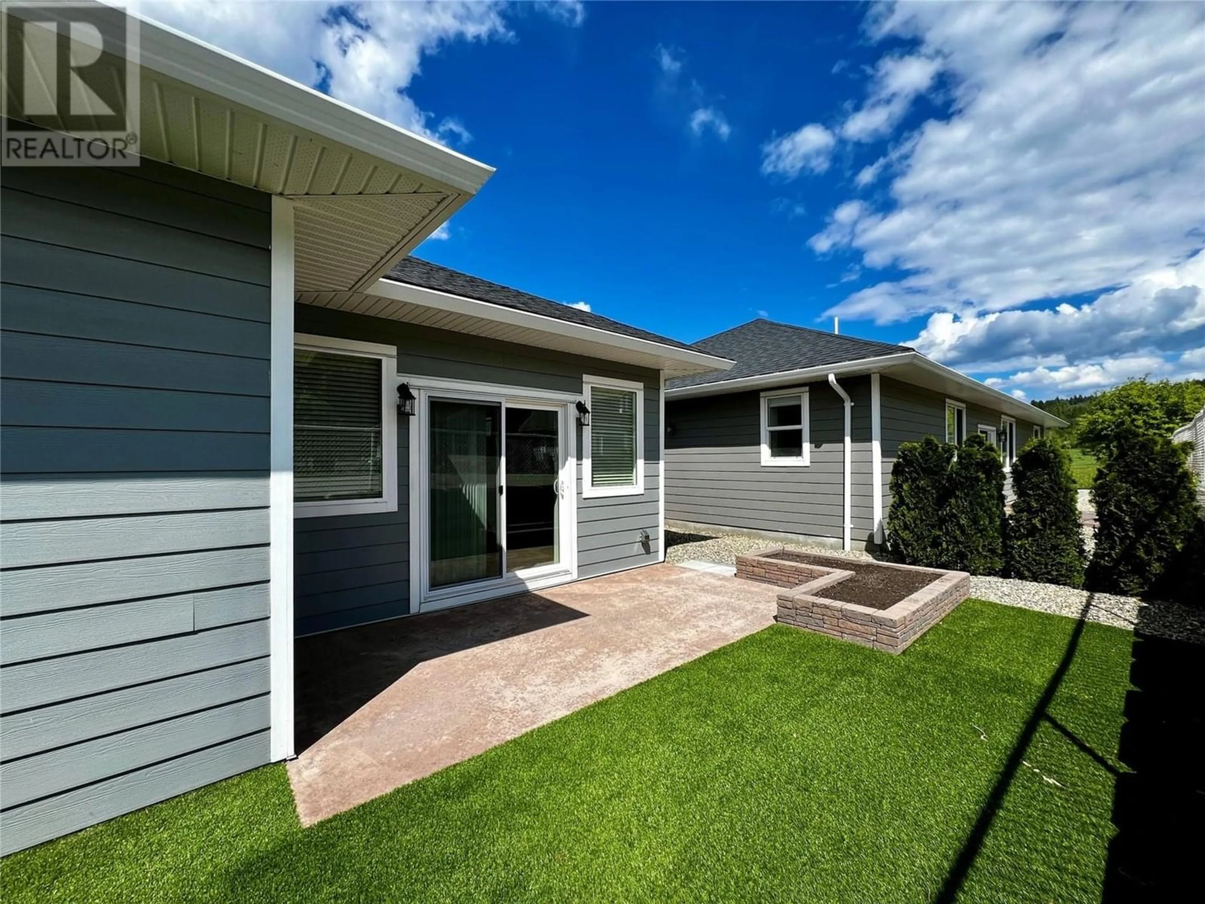 Frontside or backside of a home, the fenced backyard for 1330 10 Street SW Unit# 11, Salmon Arm British Columbia V1E0E4