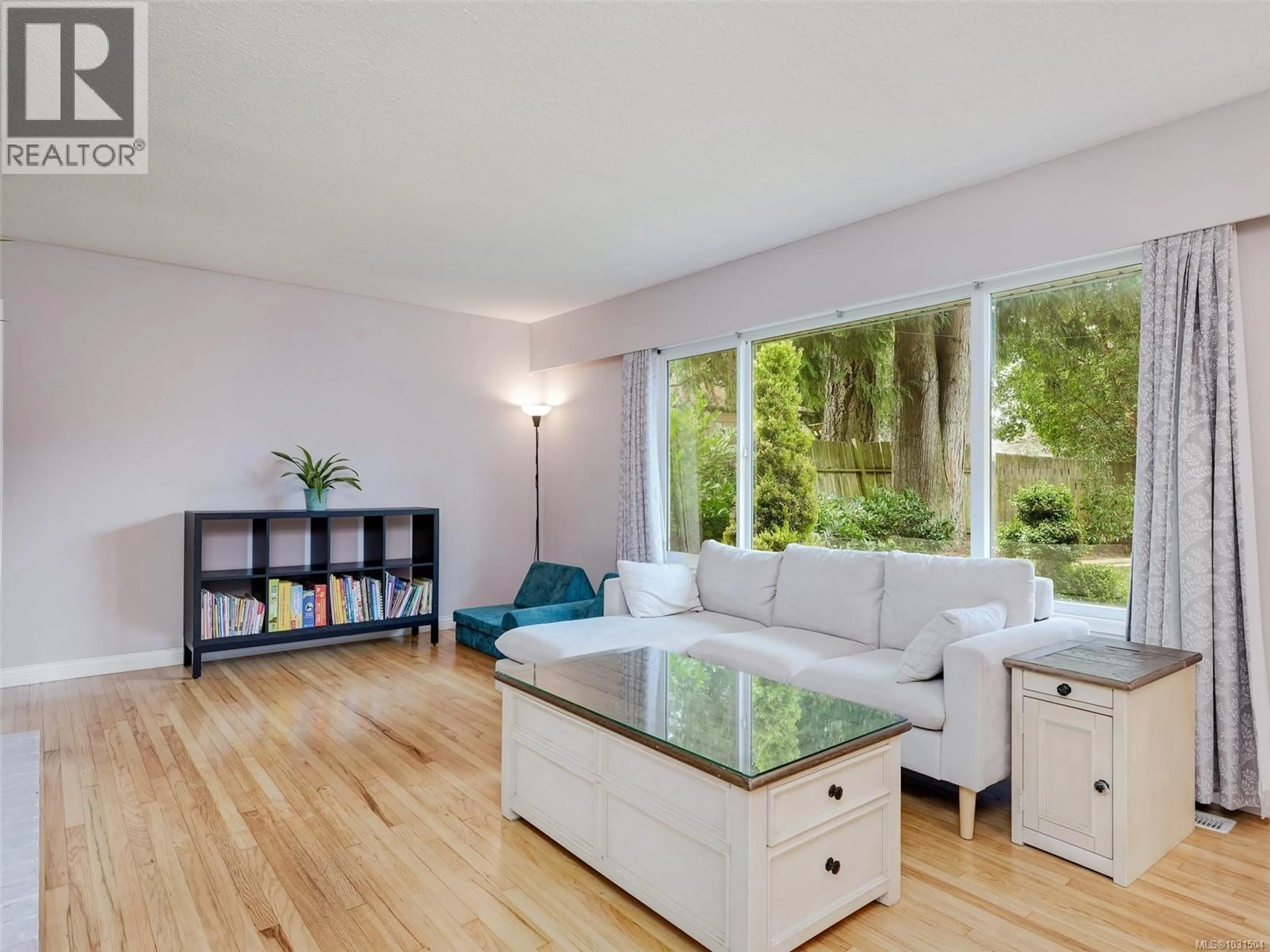 Living room with furniture, wood/laminate floor for 6429 RODOLPH ROAD, Central Saanich British Columbia V8Z5W3