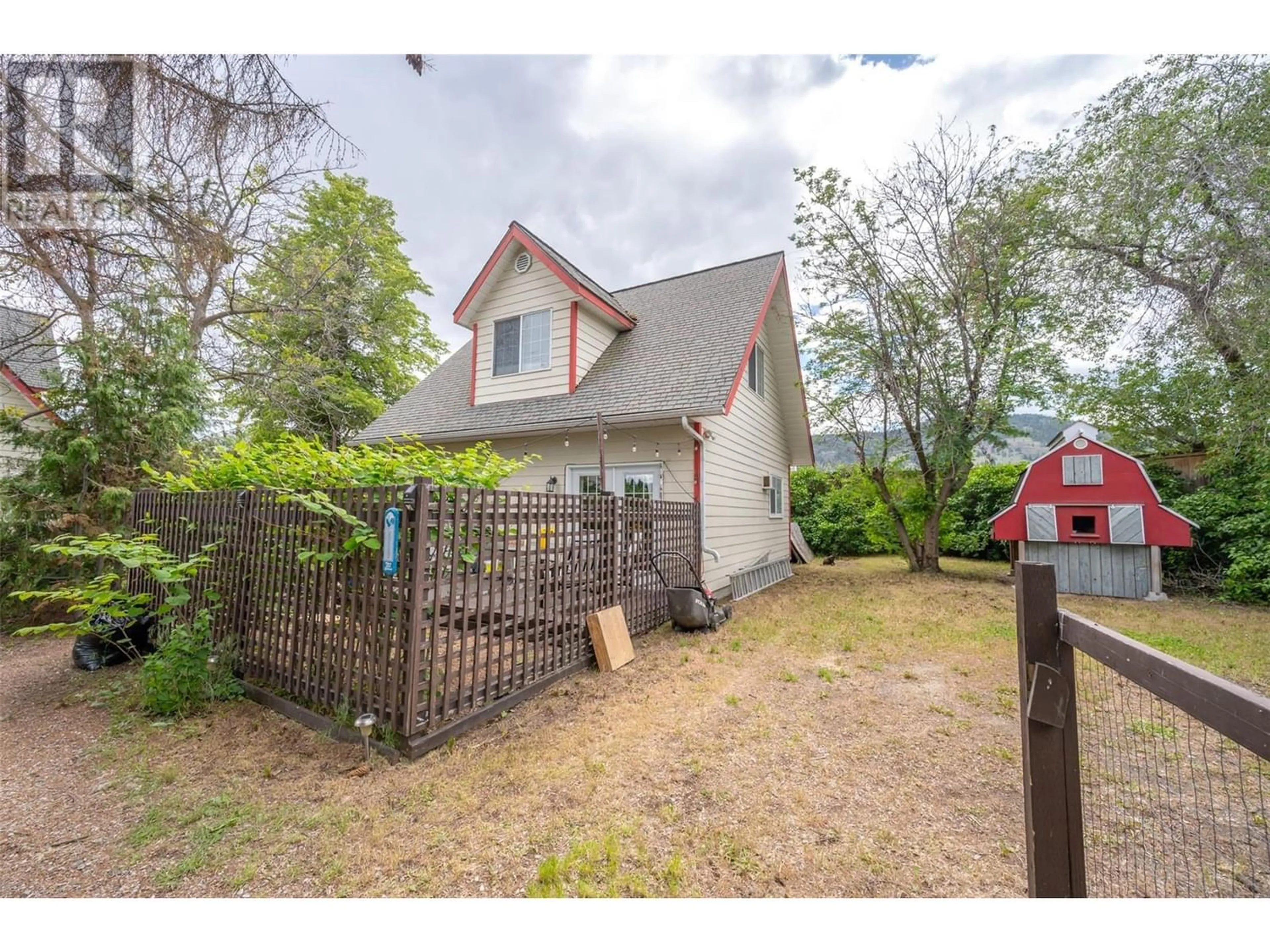 Frontside or backside of a home, the fenced backyard for 9509 Steuart Street, Summerland British Columbia V0H1Z6