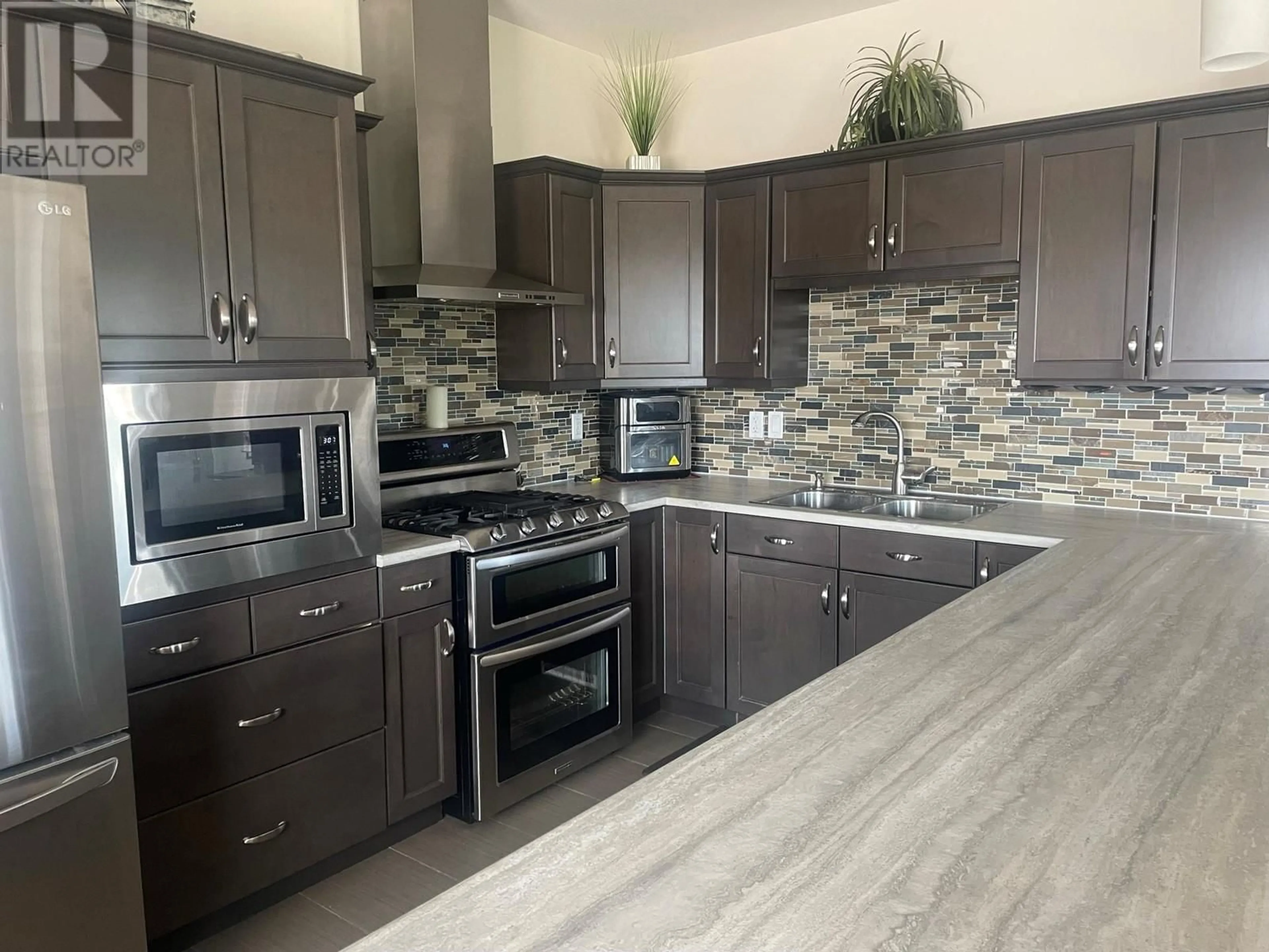 Contemporary kitchen, ceramic/tile floor for 805 89 AVENUE, Dawson Creek British Columbia V1G0A8