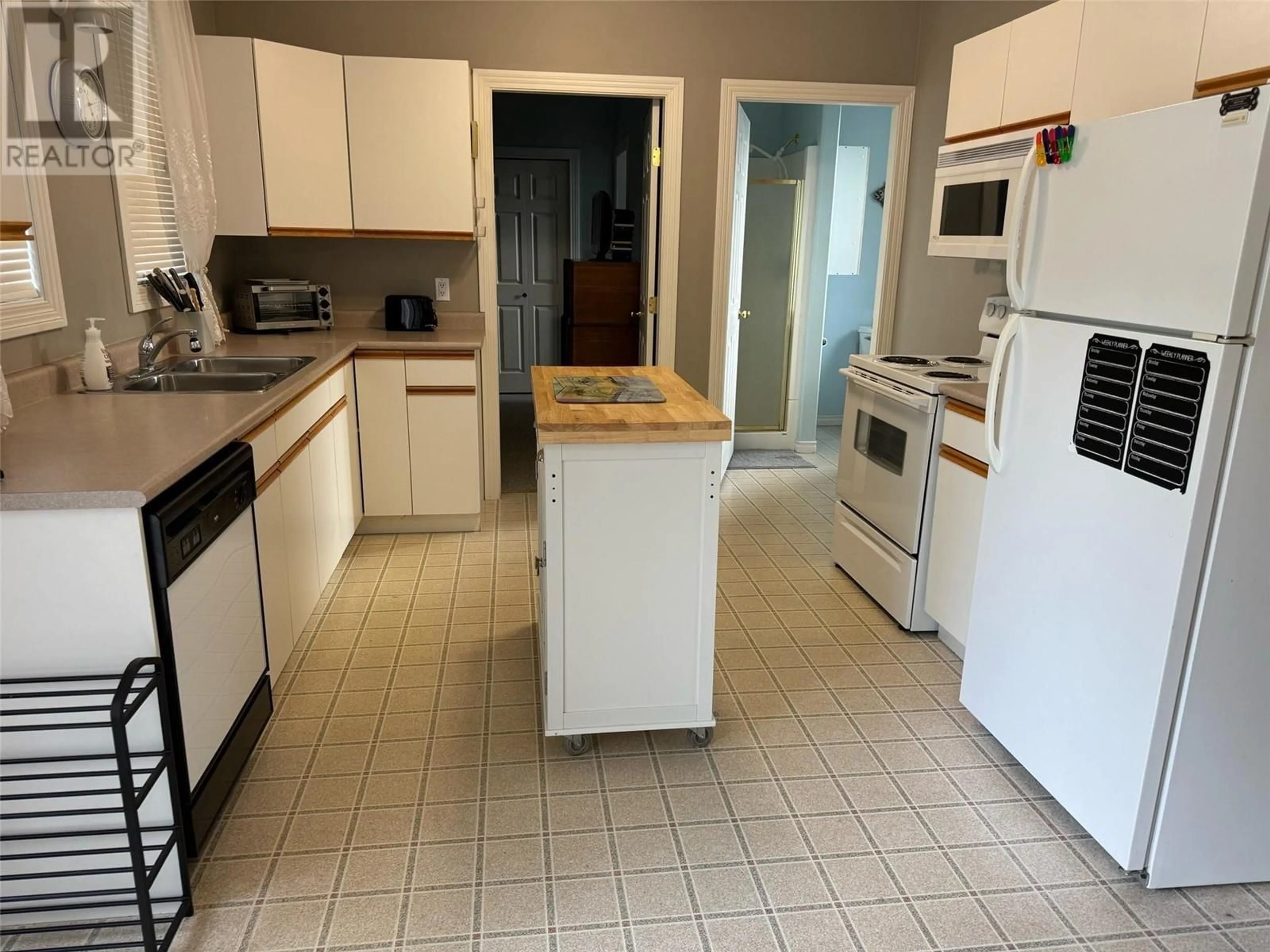 Standard kitchen, wood floors, cottage for 8248 97A Highway Unit# 20, Sicamous British Columbia V0E2Y0