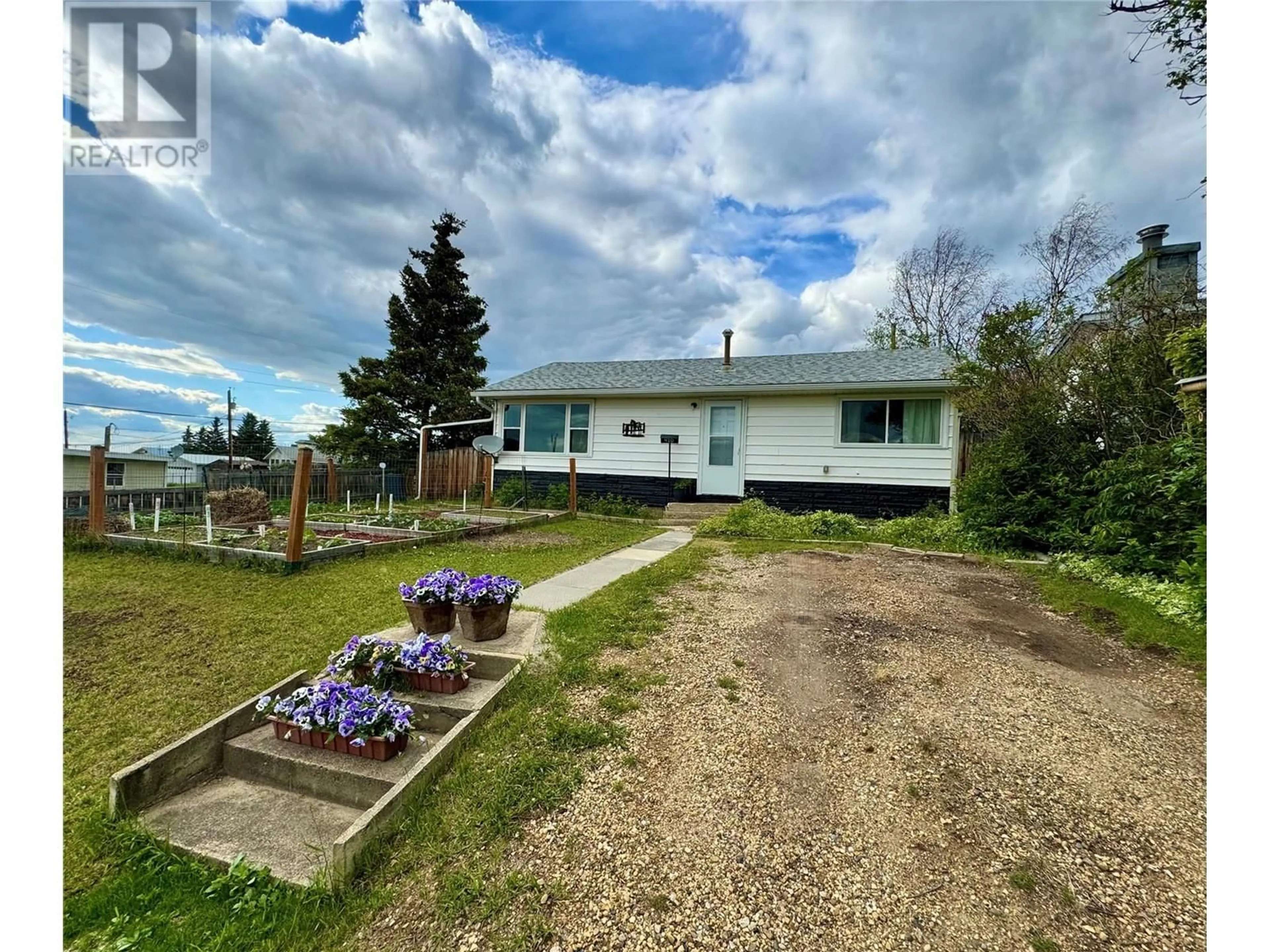 A pic from outside/outdoor area/front of a property/back of a property/a pic from drone, unknown for 420 100A Avenue, Dawson Creek British Columbia V1G1X6