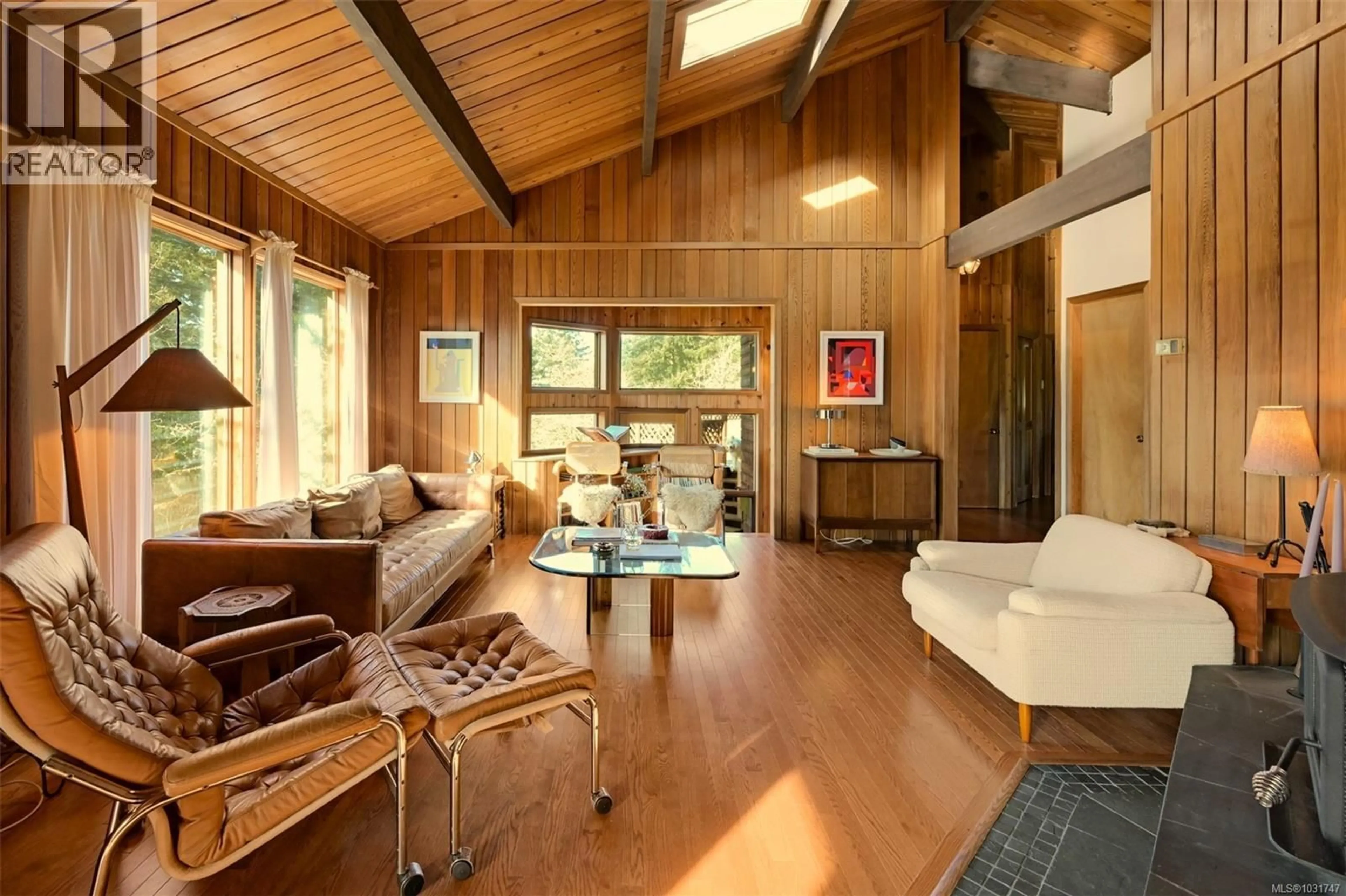 Living room with furniture, wood/laminate floor for 6587 WEST SAANICH ROAD, Central Saanich British Columbia V8M1W8