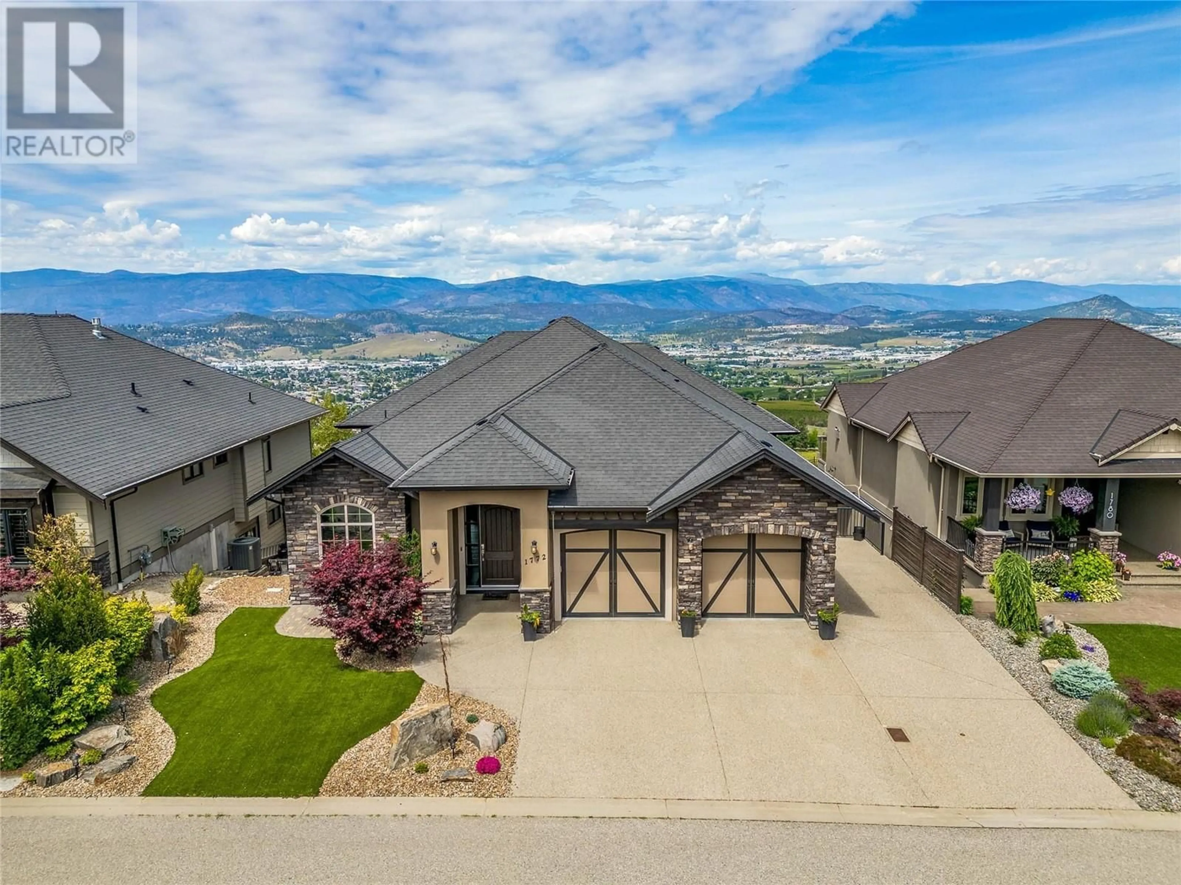 A pic from outside/outdoor area/front of a property/back of a property/a pic from drone, mountain view for 1772 Birkdale Avenue, Kelowna British Columbia V1P1R8