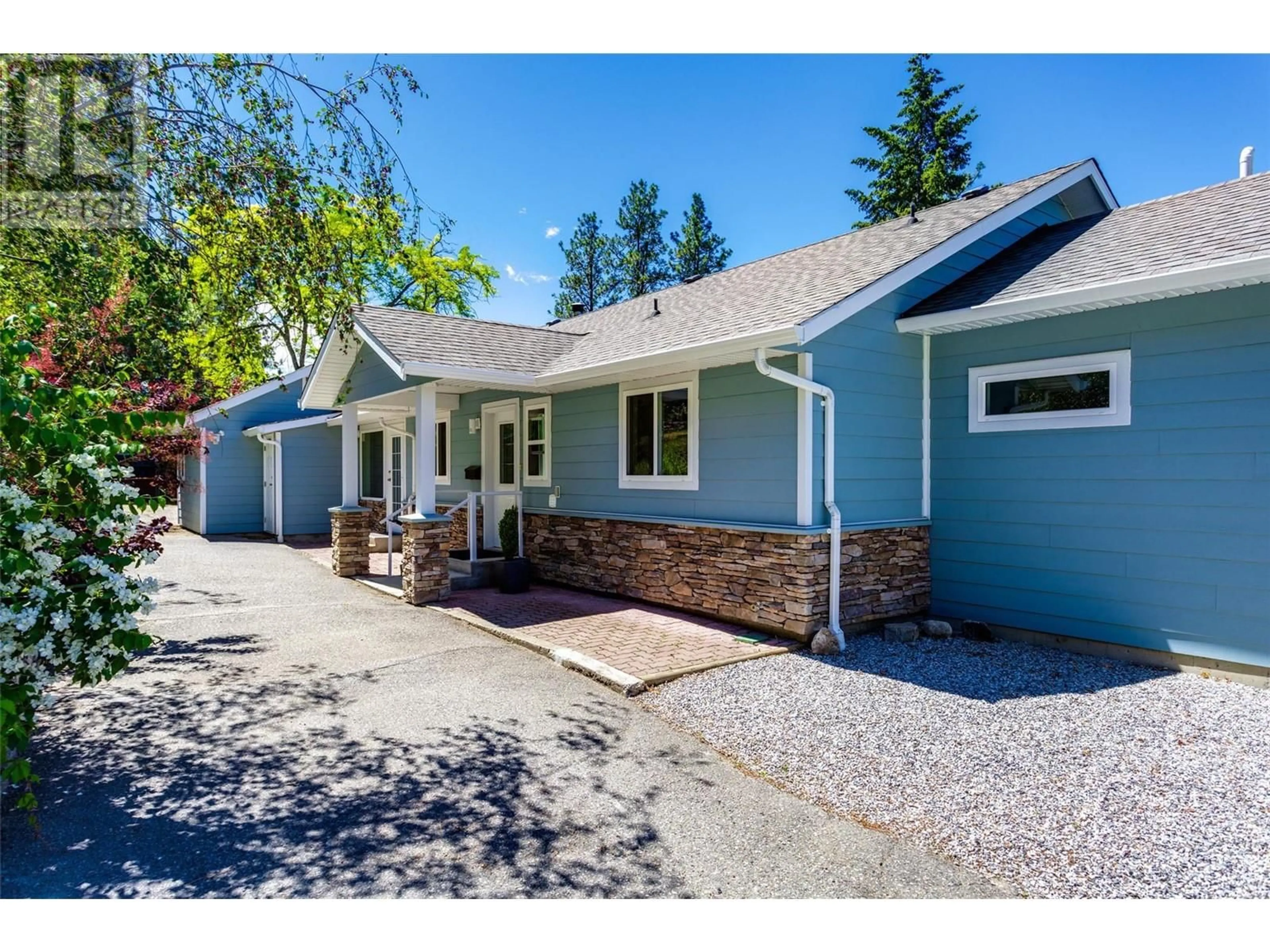 Home with vinyl exterior material, street for 1301 Lewis Road, Kelowna British Columbia V1P1C7