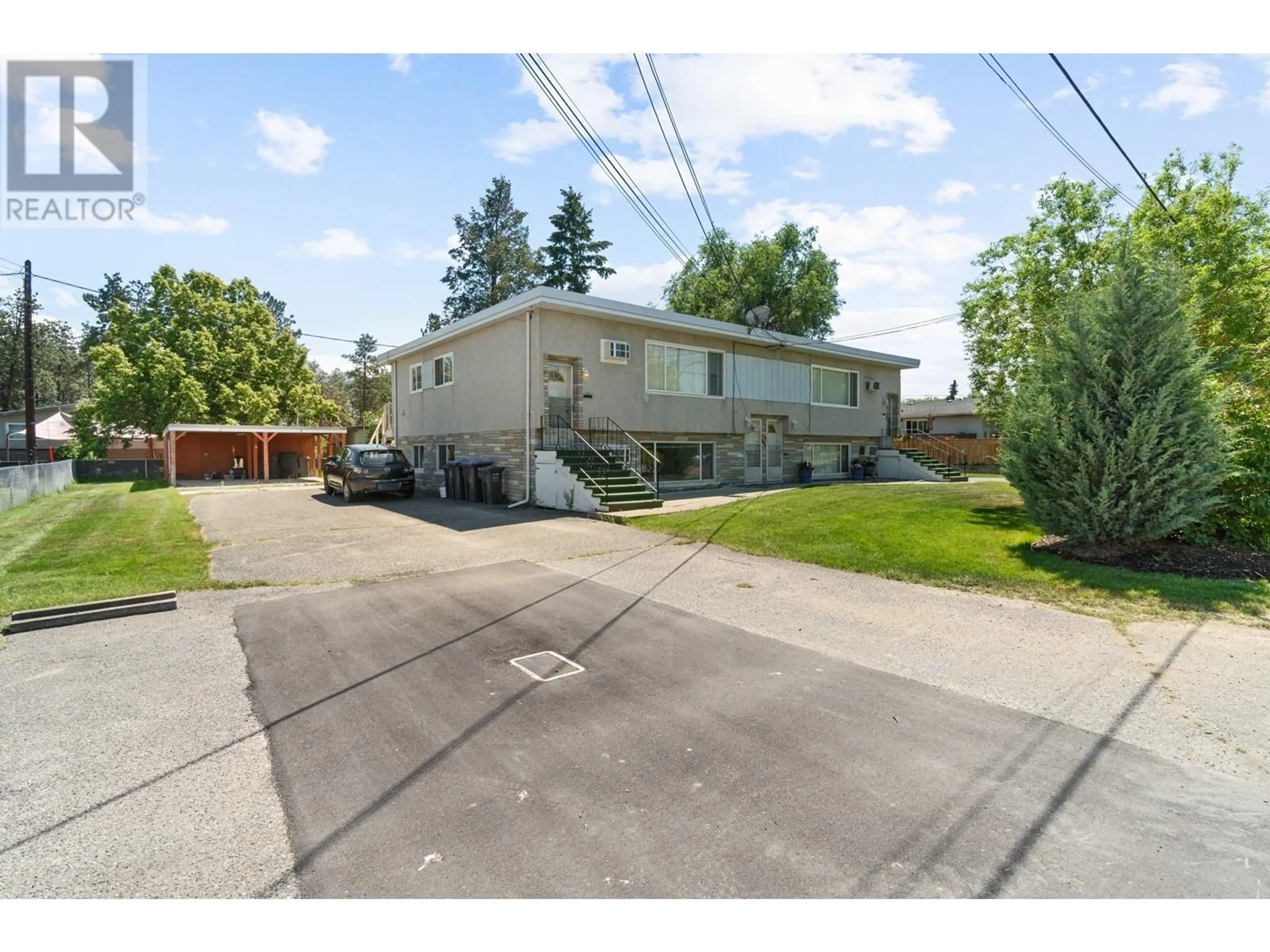 Frontside or backside of a home, the fenced backyard for 305 Cambie Road, Kelowna British Columbia V1X3J1