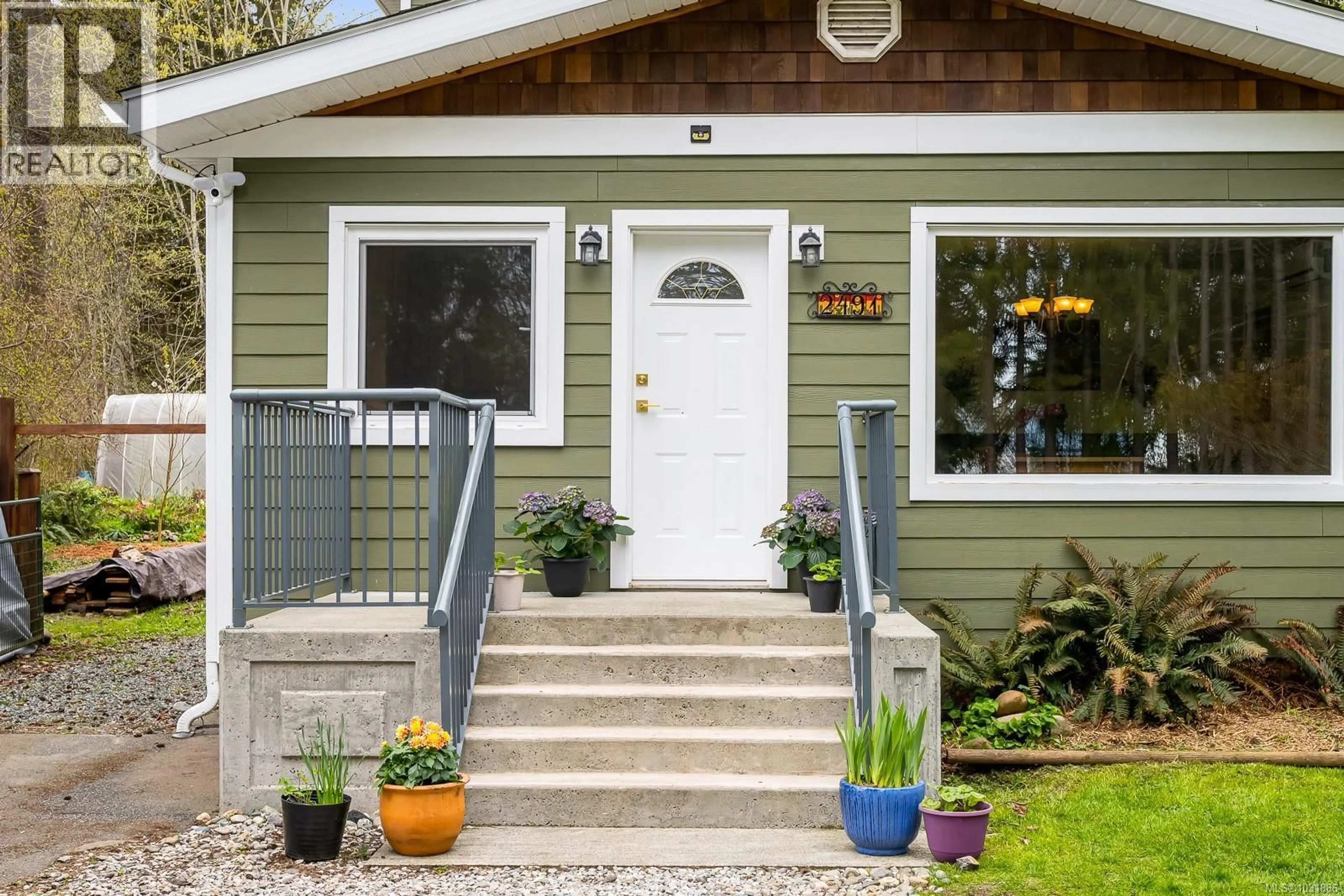 Home with vinyl exterior material, street for 2491 OAKES ROAD, Black Creek British Columbia V9J1J1