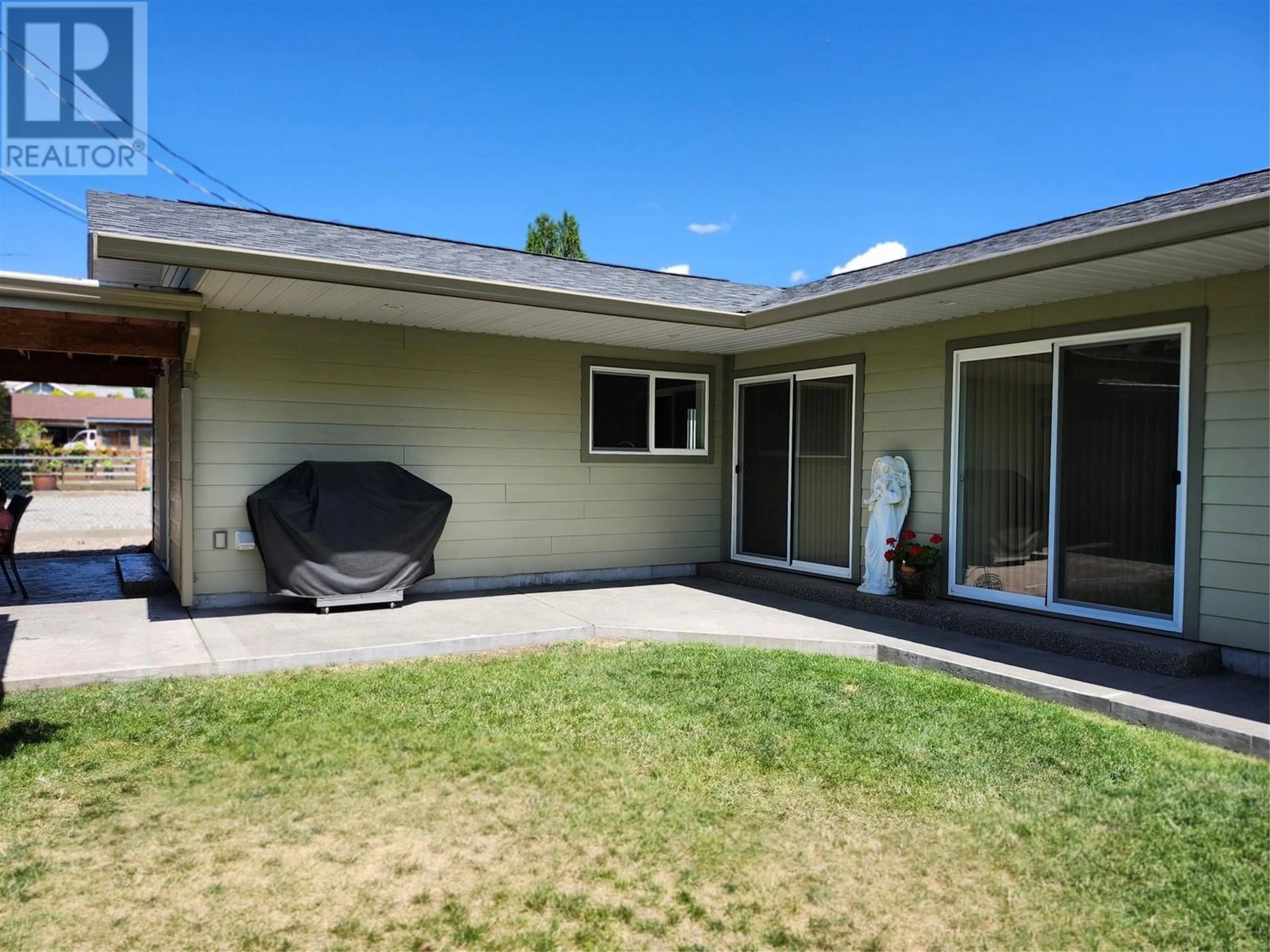 Frontside or backside of a home, the fenced backyard for 6453 Park Drive, Oliver British Columbia V0H1T3