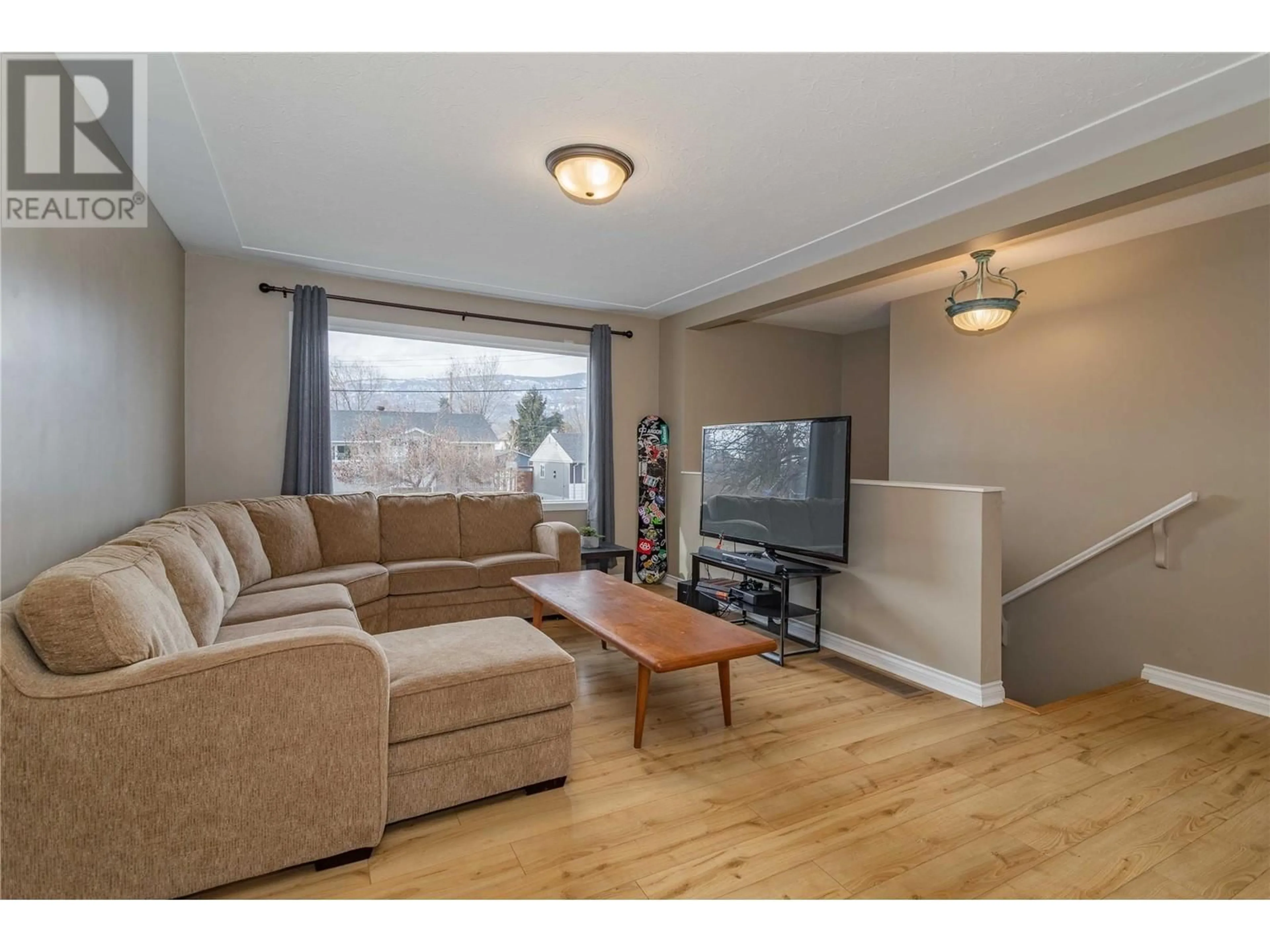 Living room with furniture, wood/laminate floor for 885 WALROD STREET, Kelowna British Columbia V1Y2S4