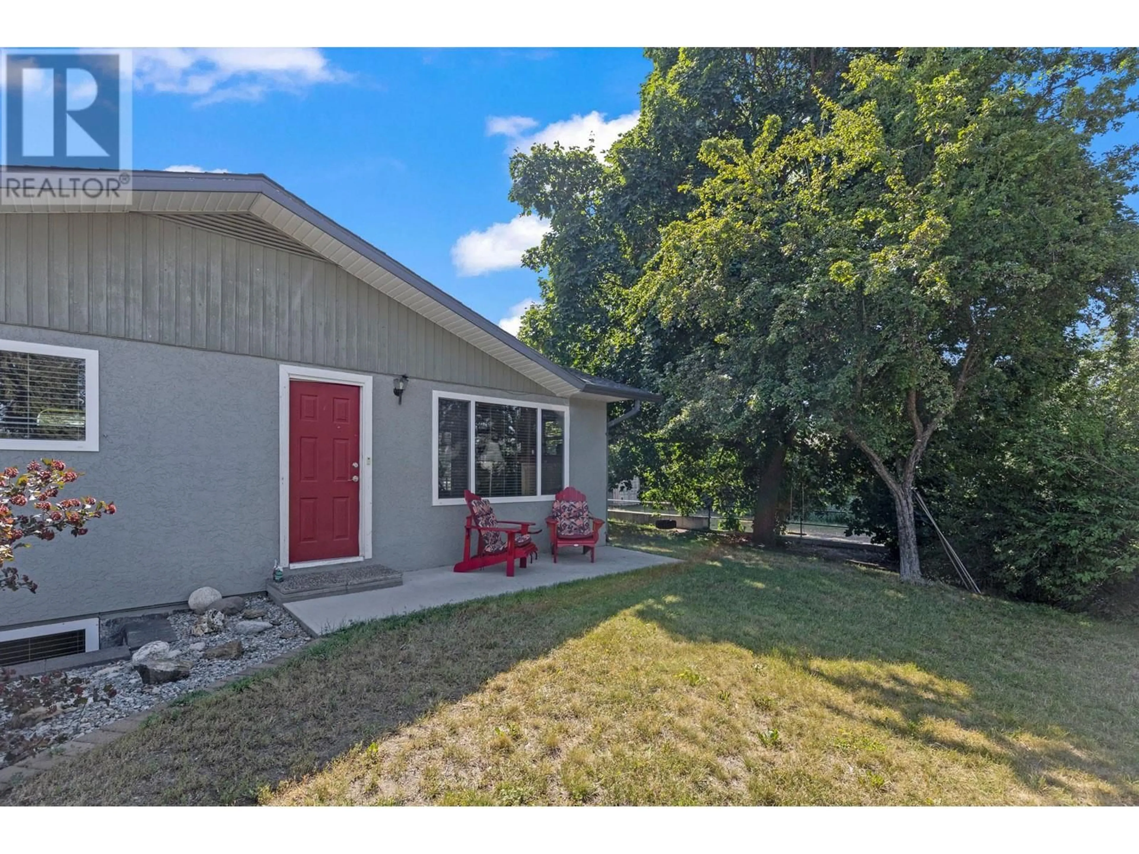 A pic from exterior of the house or condo, the fenced backyard for 4151 Sealy Road, Kelowna British Columbia V1W4C4