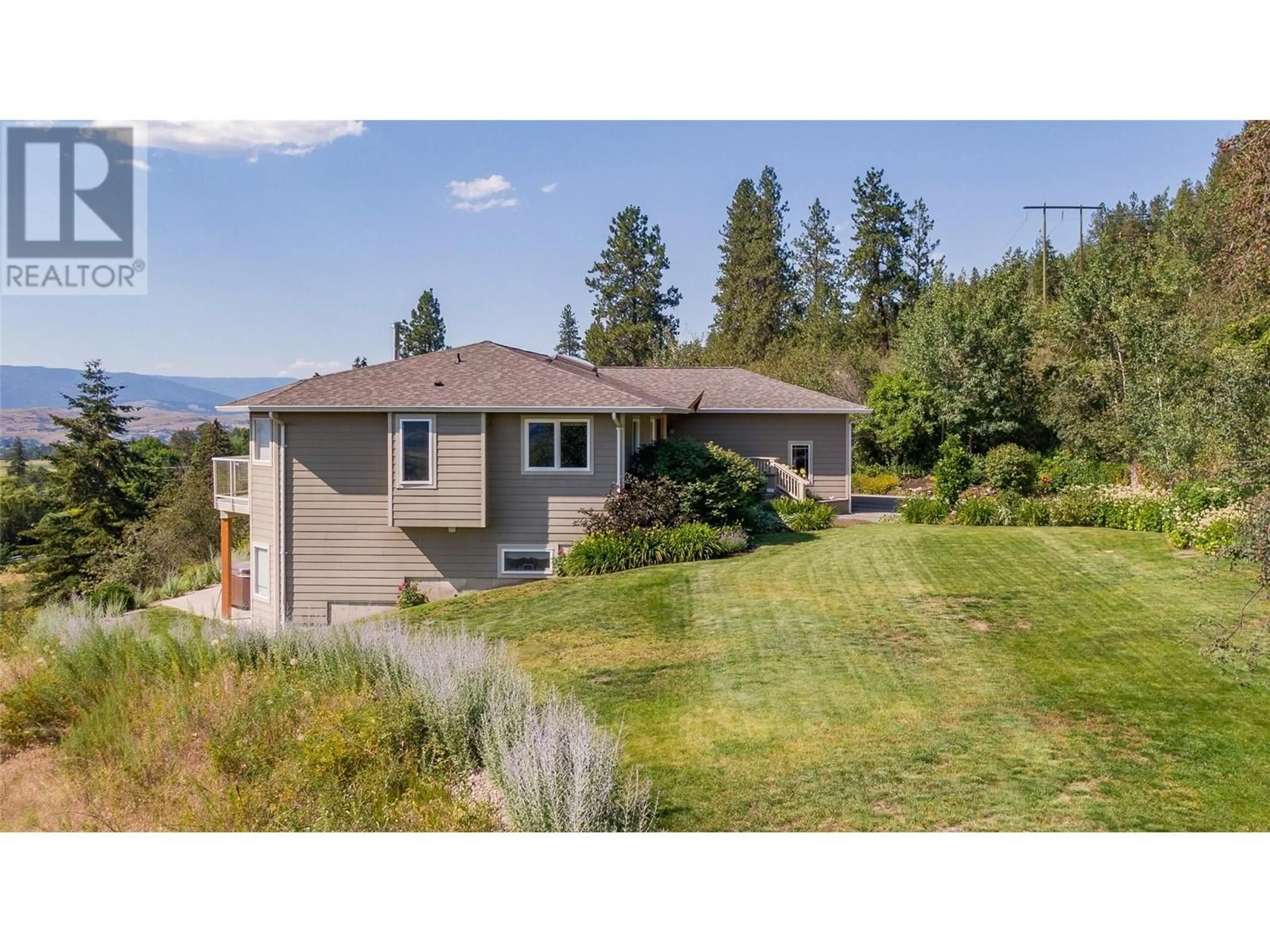 Frontside or backside of a home, the fenced backyard for 996 Galiano Road, Vernon British Columbia V1B3B3