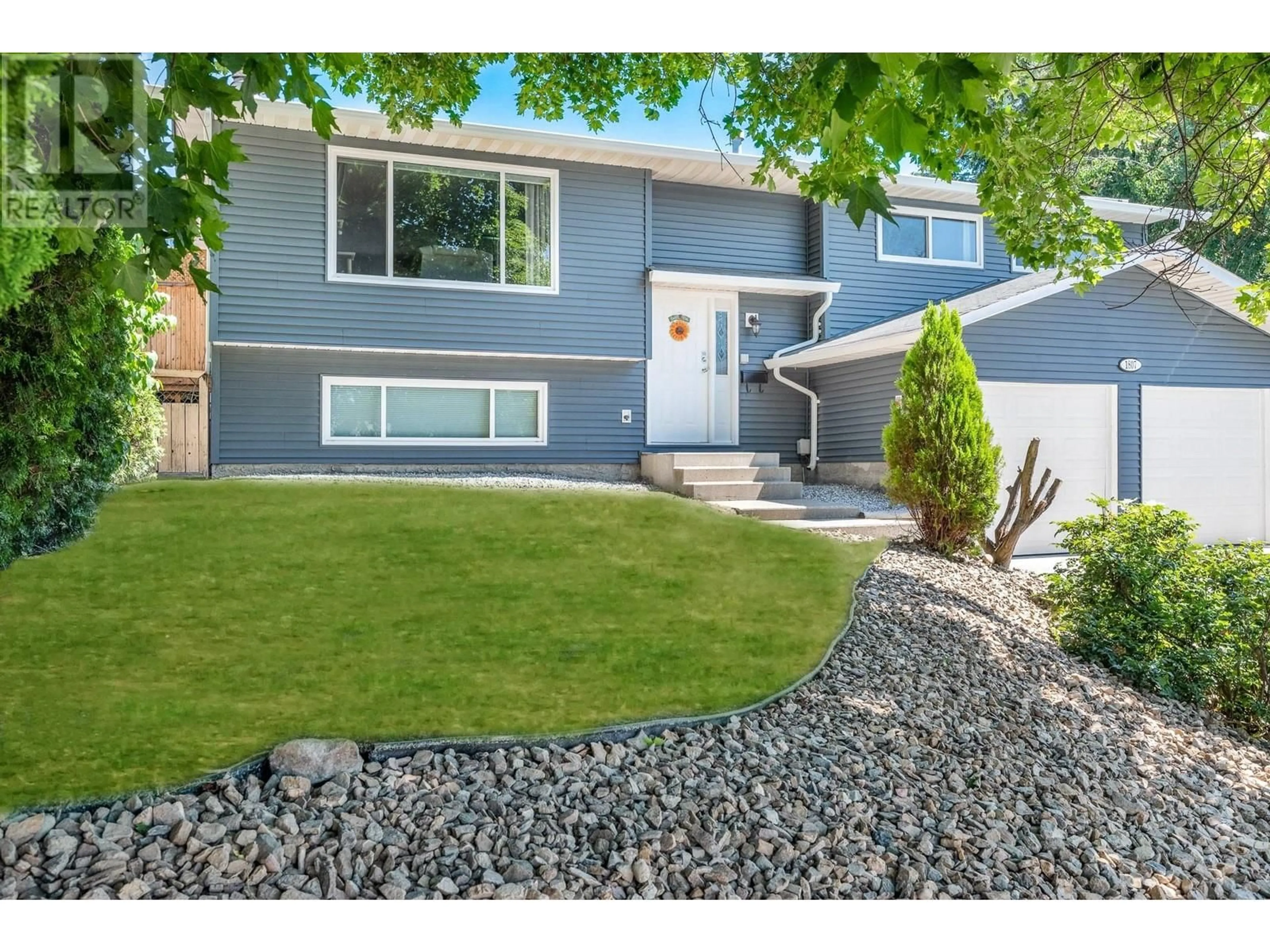 Frontside or backside of a home, the fenced backyard for 1807 22 Street, Vernon British Columbia V1T7Z9